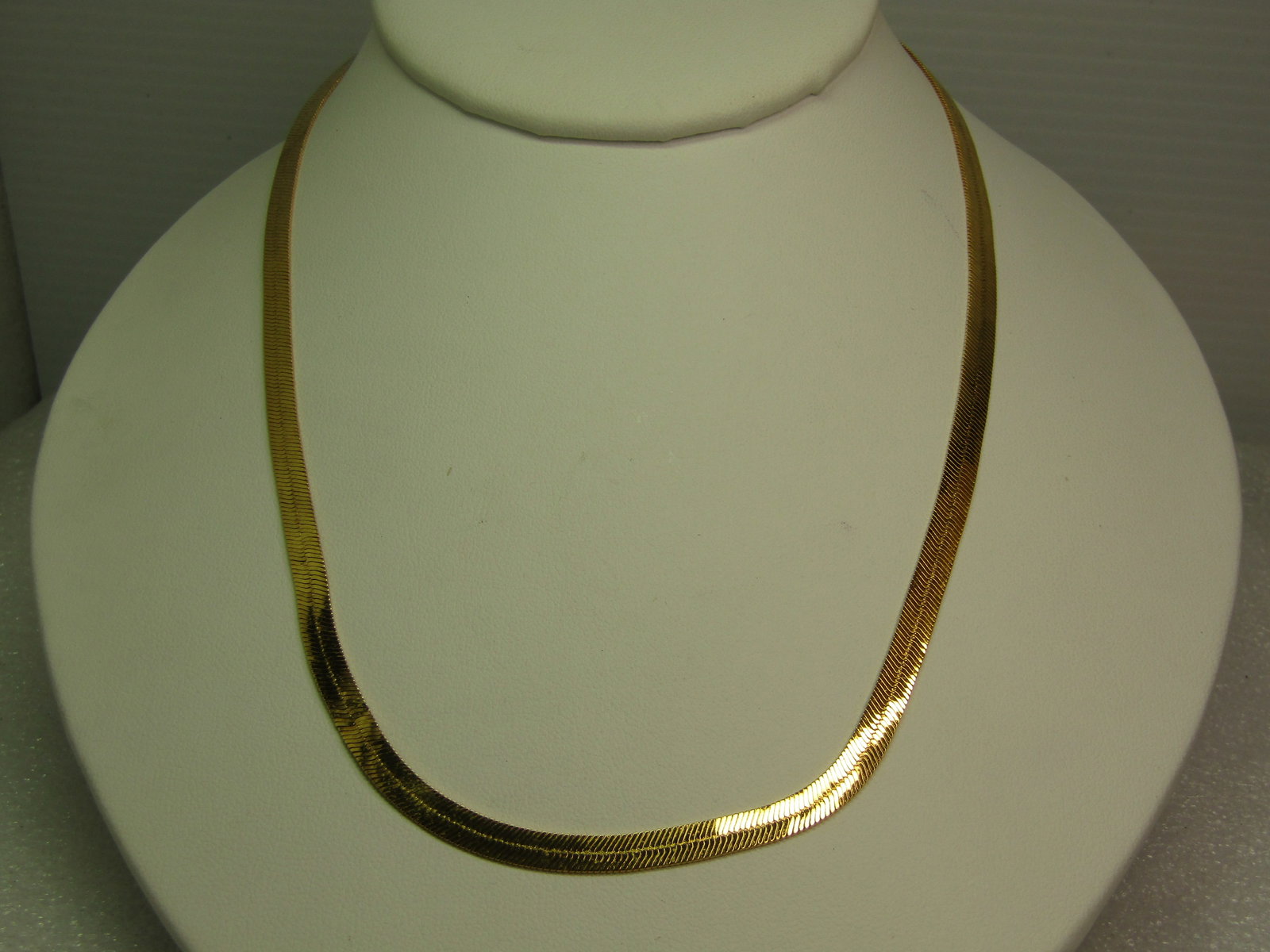 Vintage Monet Herringbone Necklace, 17.5", Gold tone, 1980's-1990's: Vintage Monet Herringbone Necklace, 17.5", Gold tone, 1980's-1990's. Gold tone with lobster clasp and Monet hang tag. It is appx. 4.5mm wide. Very clean and in very good condition. (W9.13.8 SS16320 J 