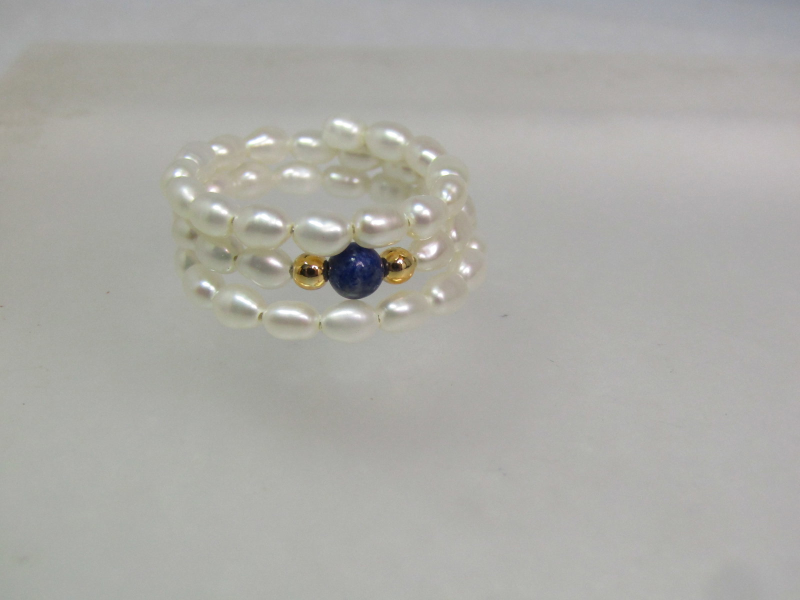 Triple Coiled Freshwater Pearl Ring, Sodalite/Gold Beads, Adjustsable, 1980's-1990's: Triple Coiled Freshwater Pearl Ring, Sodalite/Gold Beads, Adjustable, 1980's-1990's This is a size 7 and up - will adjust to the finger as the coil will just open further - but it will not work going