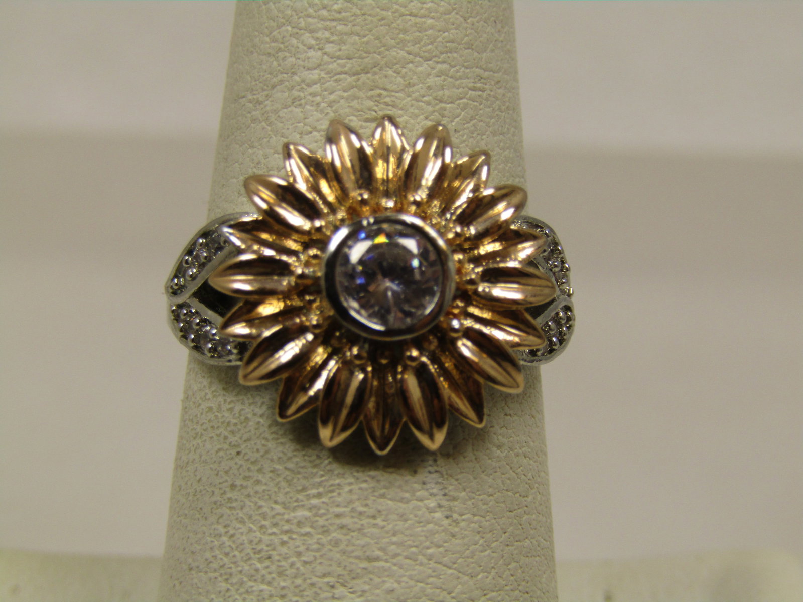Two-Tone Clear Rhinestone Sunflower Ring, Sz. 7.: Two-Tone Clear Rhinestone Sunflower Ring, Sz. 7. This has a raised bezel-set 6mm clear stone in the center of the yellow gold tone sunflower blossom. The blossom is appx. 16.5mm wide. The stone in the