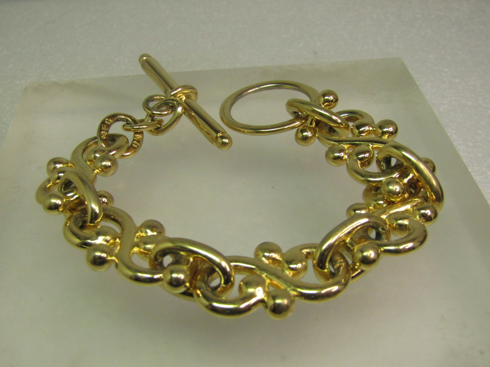 Vintage Wide S Fancy Link Bracelet, Togget Clasp, 8", Signed F.O., 1980's-1990's: Vintage Wide Infinity Fancy Link Bracelet, Togget Clasp, 8", Signed F.O., 1980's-1990's is the best estimate for this piece. The maker F.O. is unknown - there are a few companies that used this mark