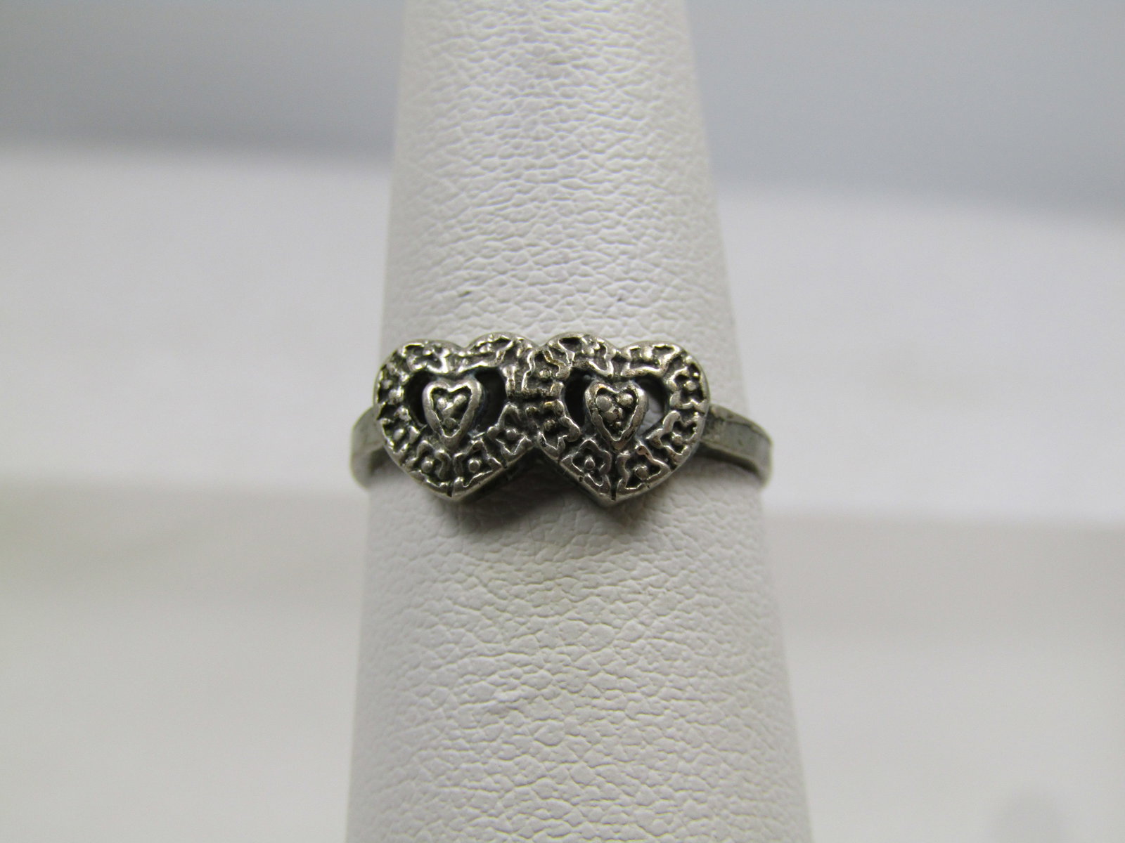 Vintage Sterling Double Heart Ring, Sz. 5.5, 1960's-1970's: Vintage Sterling Double Heart Ring, Sz. 5.5, 1960's-1970's . This is two larger hearts with a smaller heart inside each heart with open work between the hearts. The ring is appx. 6.5mm down the finger