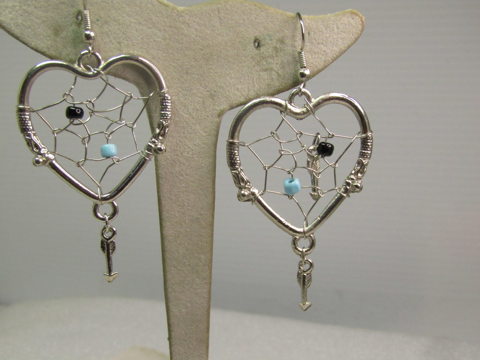 Vintage Heart Dreamcatcher Earrings: Vintage Heart Dreamcatcher Earrings, Pierced, 1970's-1980's. These are pierced with silver tone hook clasps and silver tone herats with a black and turquoise glass bead in each of the nets of the drea