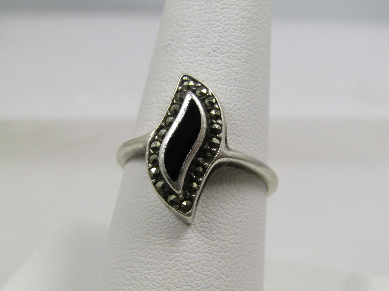Vintage Sterling Inlaid Onyx Marcasite Ring, Sz. 8.25, 1980's, Signed: Vintage Sterling Inlaid Onyx Marcasite Ring, Sz. 8.25, 1980's, Signed with what looks like NF and marked .925 and tests as sterling with an appx. weight of 3.55 grams. This has a pointed curved design