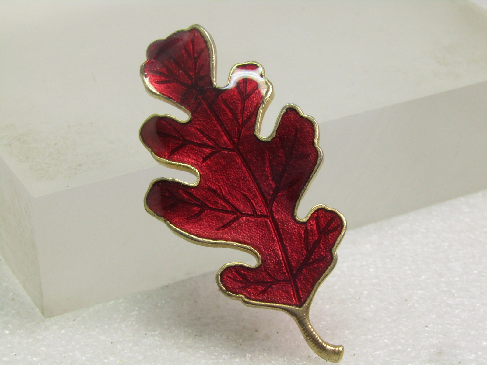 Vintage Maroon Enameled Laminated Leaf Brooch, 1960's-1970's: Vintage Maroon Enameled Laminated Leaf Brooch, 1960's-1970's. This is appx. 2.5" tall and slightly over 1" wide. Gold tone back and framing with stem. Locking clasp. it is not signed or marked. Very g