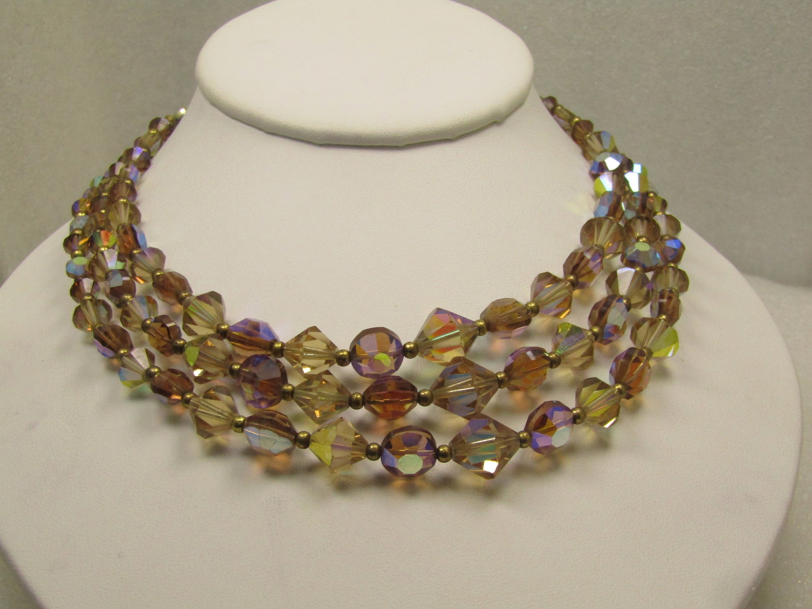 Vintage Triple Strand Brown Crystal Aurora Borealis Necklace, 16", 1950's-1960's.: Vintage Triple Strand Brown Crystal Aurora Borealis Necklace, 16", 1950's-1960's. The beads are diamond shaped and faceted alternating with round flat table on both sides faceted beads with gold tone 