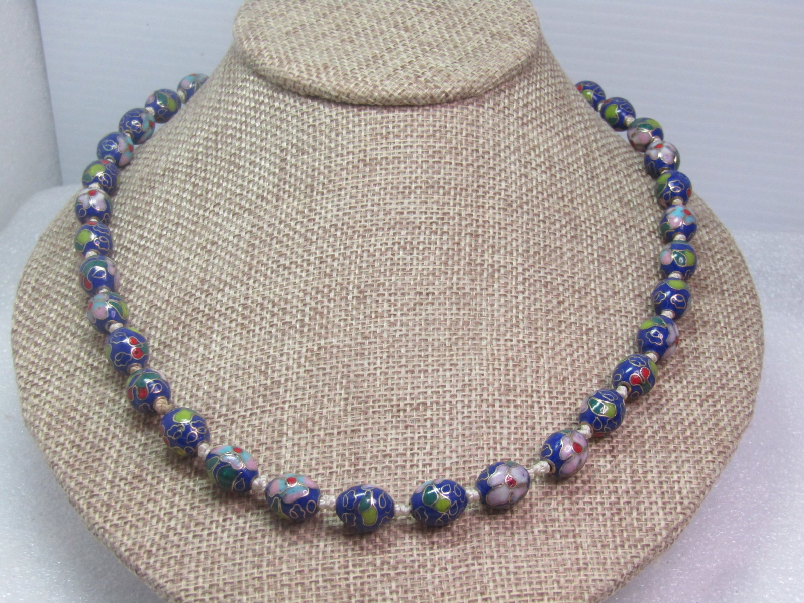 Vintage Blue Cloisonne Beaded Necklace, Floral, 20" , Knotted, 1970's-1980's: Vintage Blue Cloisonne Beaded Necklace, 20", Knotted. 1970's-1980's. Pretty flowers and leaves in the design of the beads. These beads are slightly oval and appx. 10.5mm long and 8.5mm wide with a gol
