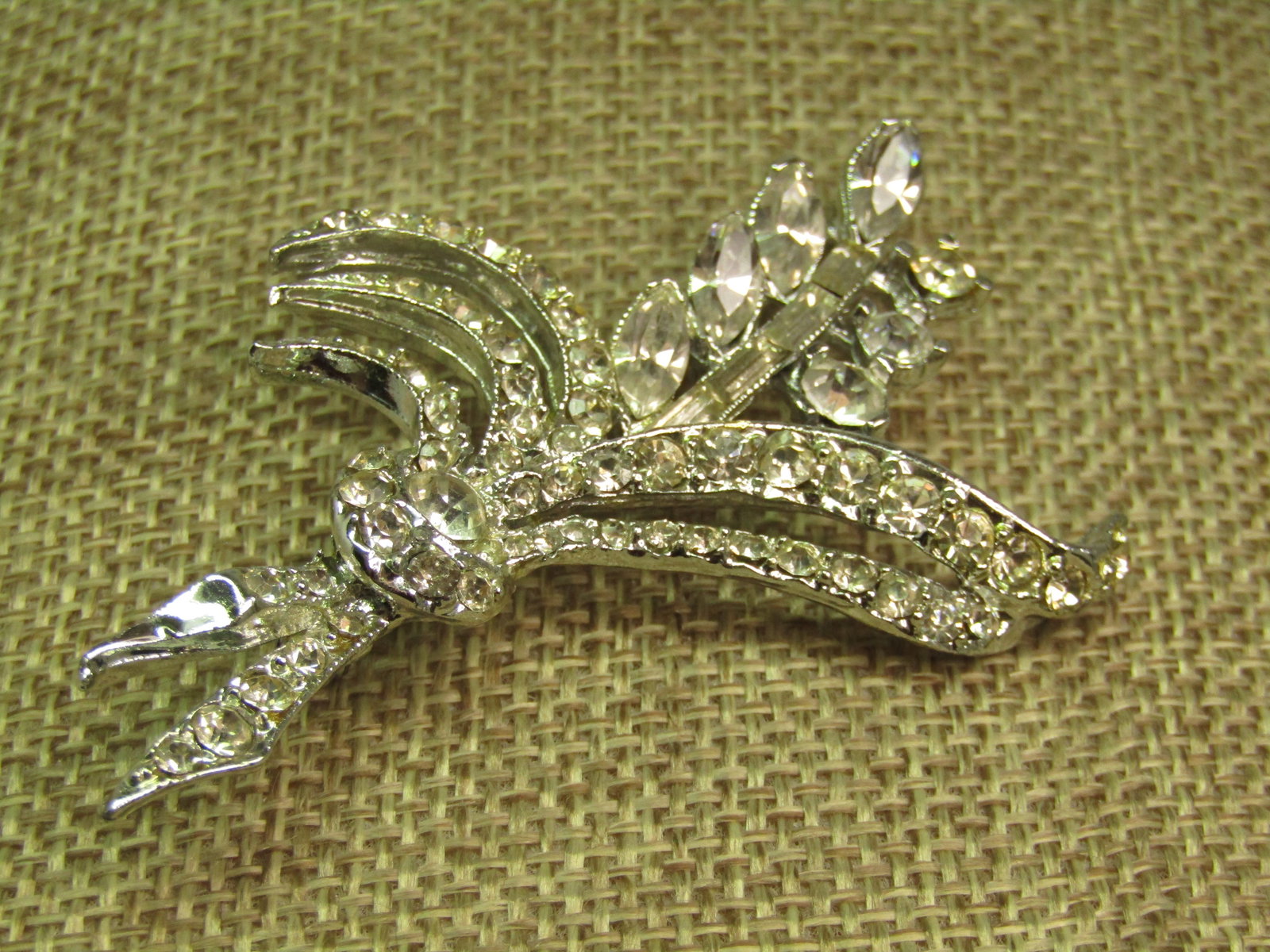 Vintage Clear Rhinestone Floral Spray Brooch, 1950's-1960's: Vintage Clear Rhinestone Floral Spray Brooch, 1950's-1960's. Silver tone with marquise, round and baguette clear glass or crystal stones. This is appx.2.5" tall and 1.75" wide. Long locking clasp that
