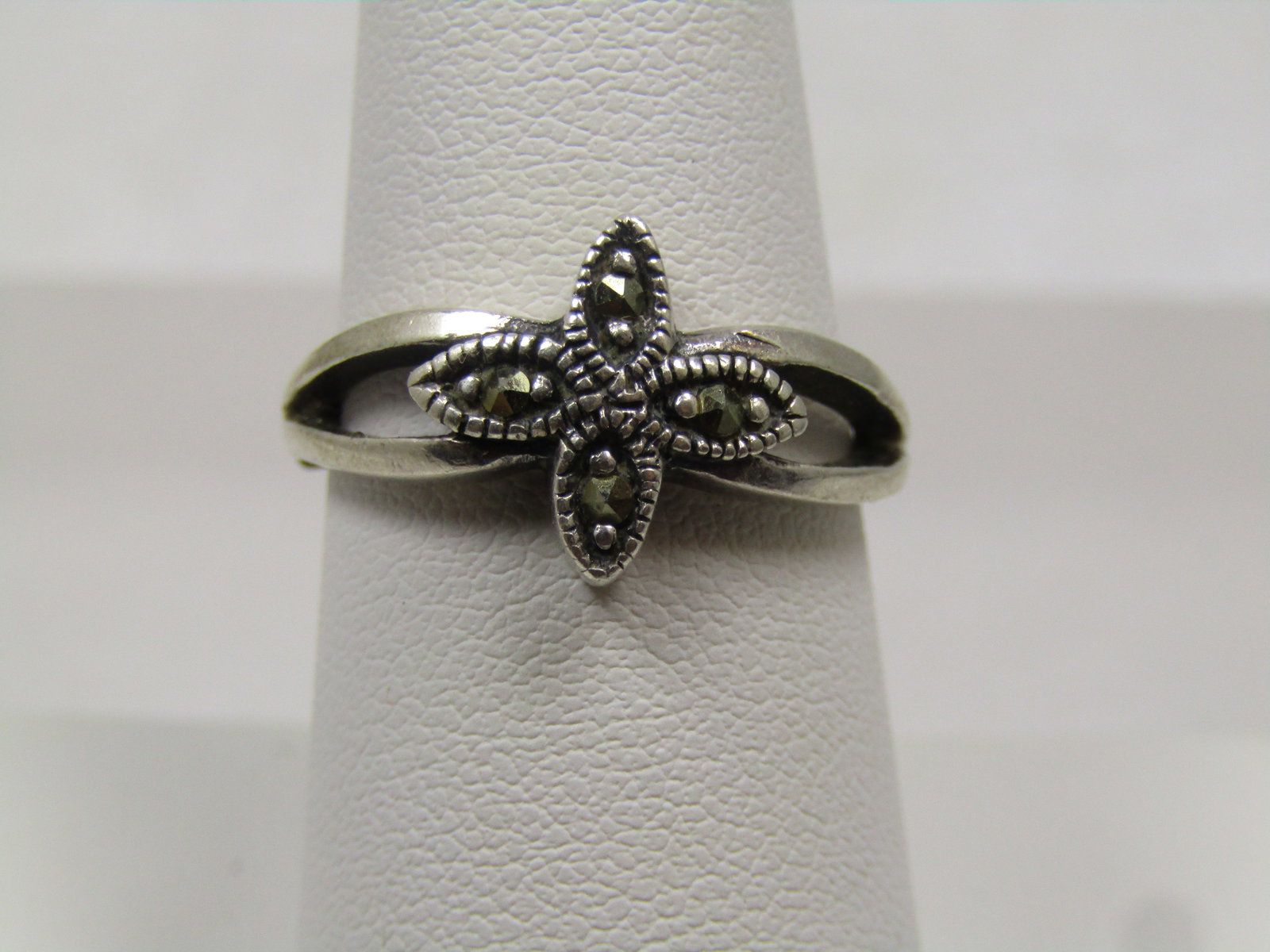 Vintage Sterling Marcasite Pointed Ring, Sz. 8, 1980's: Vintage Sterling Marcasite Pointed Ring, Sz. 8, 1980's, Signed Marsala. It has a four pronged blossom no top with pointed edges and sits on the top center of the ring. It is appx. 12mm wide going down