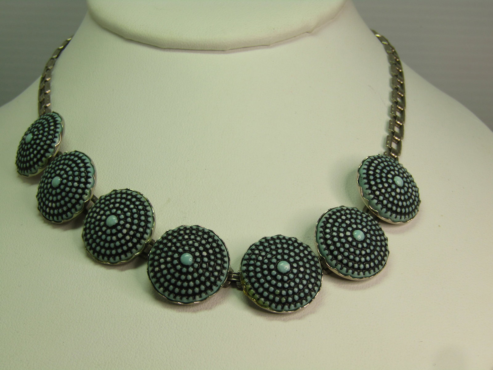 Vintage Pressed Turquoise Glass Tiered Necklace, 15", 1940's: Vintage Pressed Turquoise Glass Tiered Necklace, 15", 1940's. This has seven links with a domed pressed turquoie glass with black wash creating the look - in a way of a turquoise concho or something s