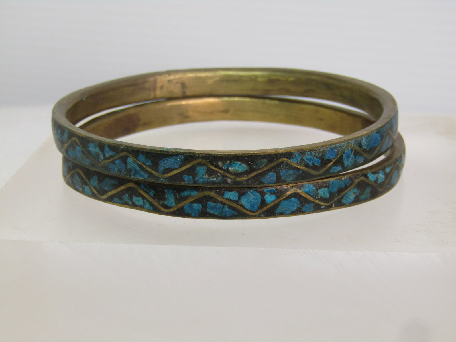 Vintage Pair Brass Inlaid Turquoise Chip Bangle Bracelets, 8.75", 1960's: Vintage Pair Brass Inlaid Turquoise Chip Bangle Bracelets, 8.75", 1960's. These are appx. 36.5mm wide and slightly domed. A rustic piece with a black background and the turquoise stone chips set in an