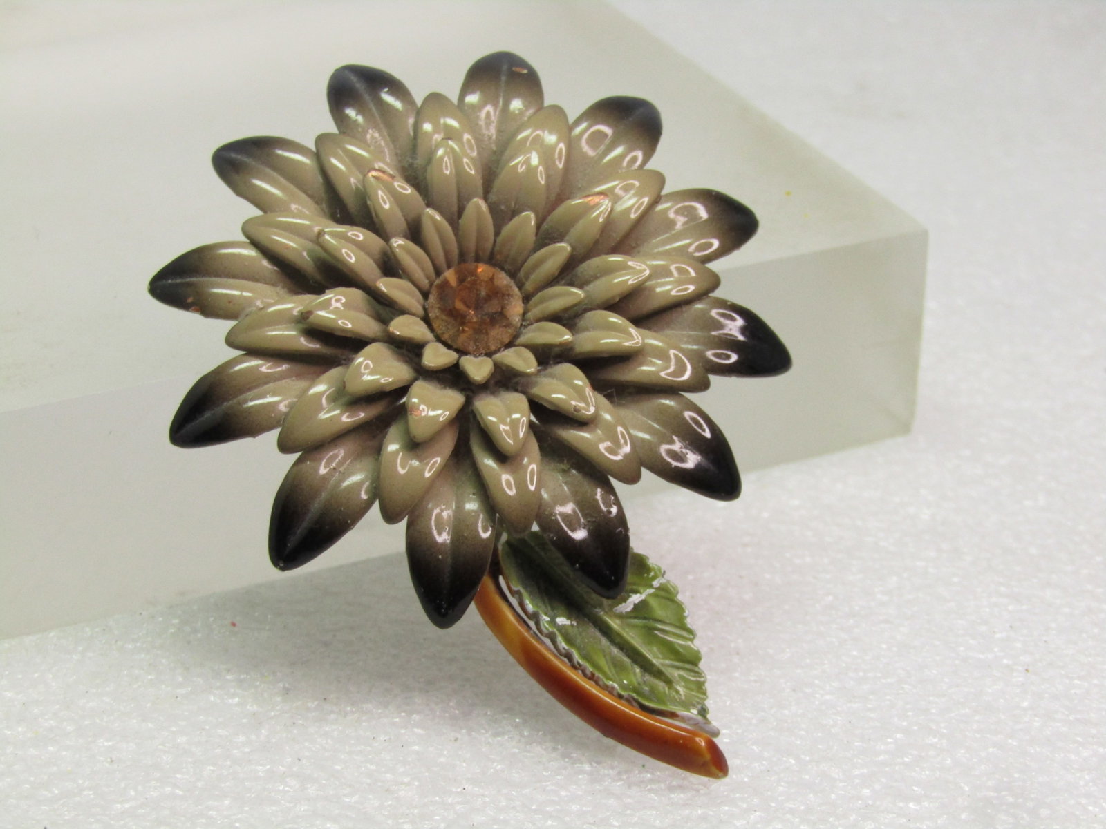 Vintage Taupe/Black Enameled Blossom Stem Brooch, RS Center, 1960's: Vintage Taupe/Black Enameled Blossom Stem Brooch, RS Center, 1960's. Great for autumn - or just a blossom brooch for every day. It has a brown enameled stem and green leave. The blossom has petals tha