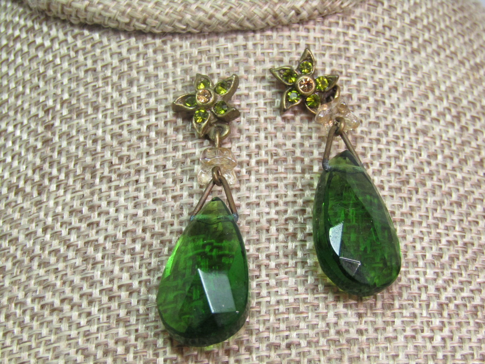 Vintage Green Glass Drop Earrings Rhinestone Stud. Pierced. 1960's-1970's: Vintage Green Glass Drop Earrings Rhinestone Stud. Pierced. 1960's-1970's. These are gold tone with a star-like stud with a yellow glass rhinestone in the center and green in the points. There is a lo
