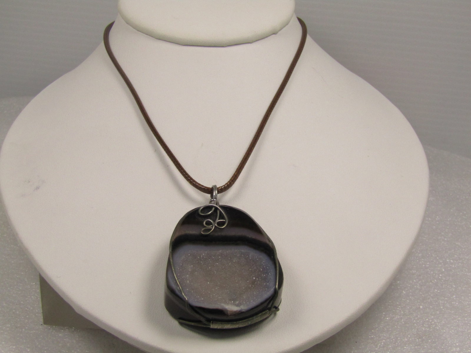 Brown Montana Druzy Agate Pendant on Brown Cord Necklace, 18"-20", 1980's-1990's: Brown Montana Druzy Agate Pendant on Brown Cord Necklace, 18"-20", 1980's-1990's. This is a thick and chunky agate with dark brown, chestnut brown and white bands and flat on the back with a depressed