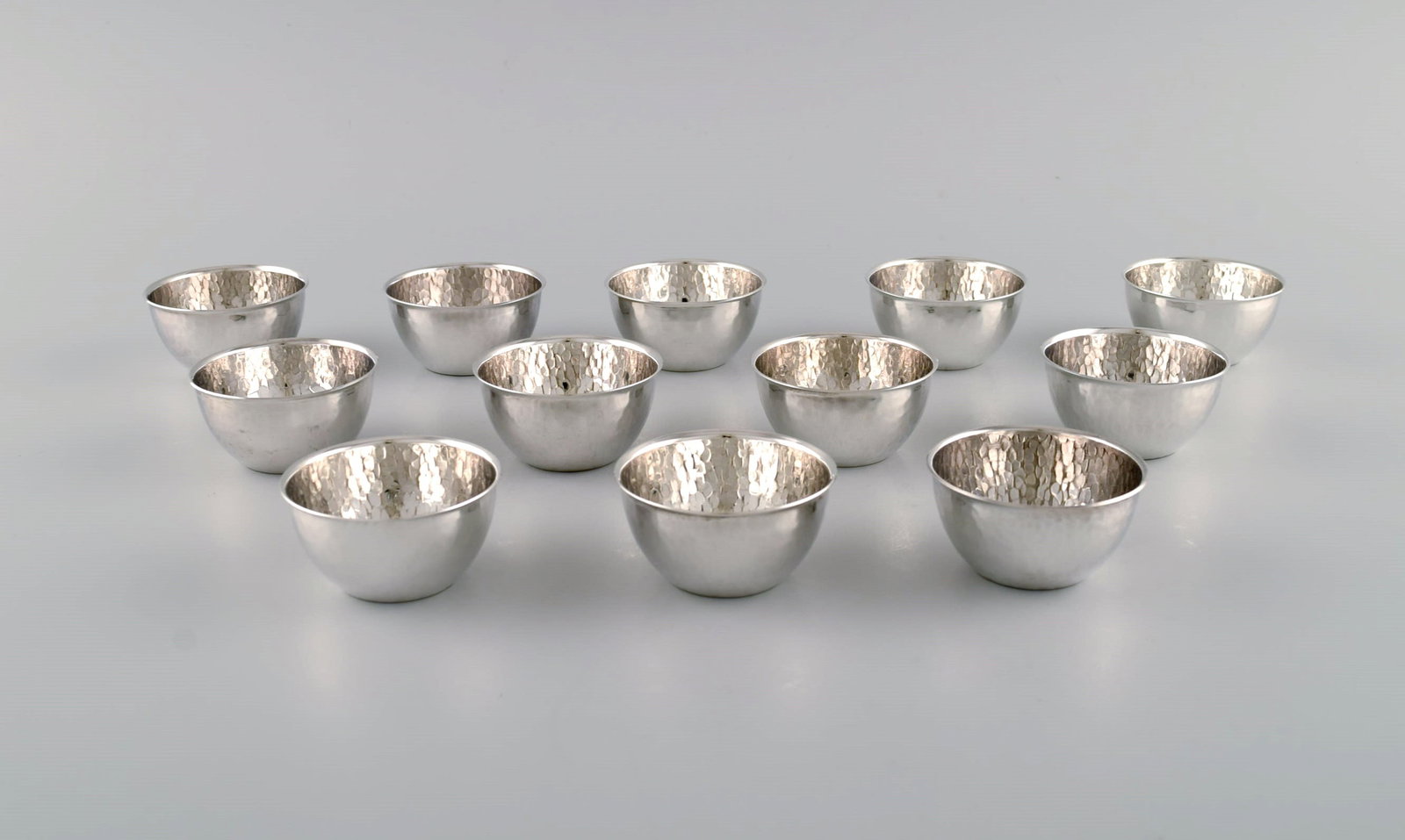 Elon Arenhill (1922-2018). Well-known Swedish silversmith. Twelve modernist cups in hammered: Title:Elon Arenhill (1922-2018). Well-known Swedish silversmith. Twelve modernist cups in hammered sterling silver. Dated 1974. Description:Elon Arenhill (1922-2018). Well-known Swedish silversmith.