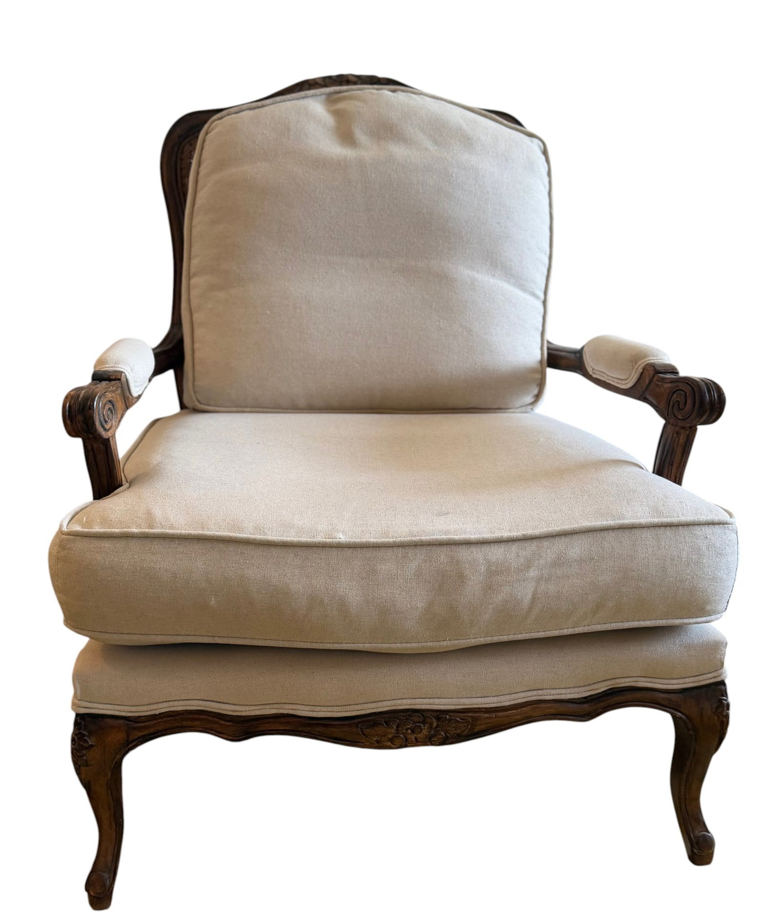 French Provincial Style Cane Back Armchair: An elegantly carved French Provincial style armchair, likely dating from the mid-20th century. The chair features a fruitwood frame with Rococo inspired carvings on the crest rail, arm supports, and a