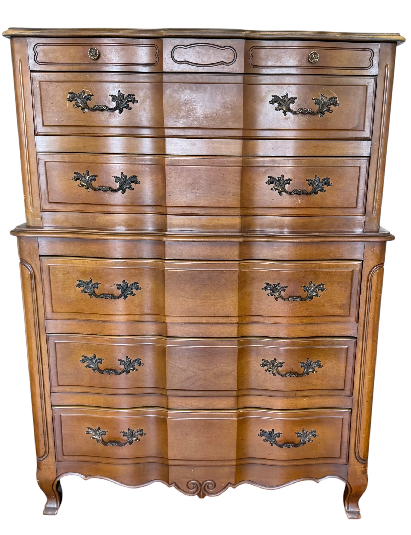 French Provincial Style Stacked Chest of Drawers, Mid 20th Century: This elegant mid-20th century stacked chest of drawers, crafted in a French Provincial style, features a warm, light-stained wood finish. The piece is composed of two distinct sections: a larger,
