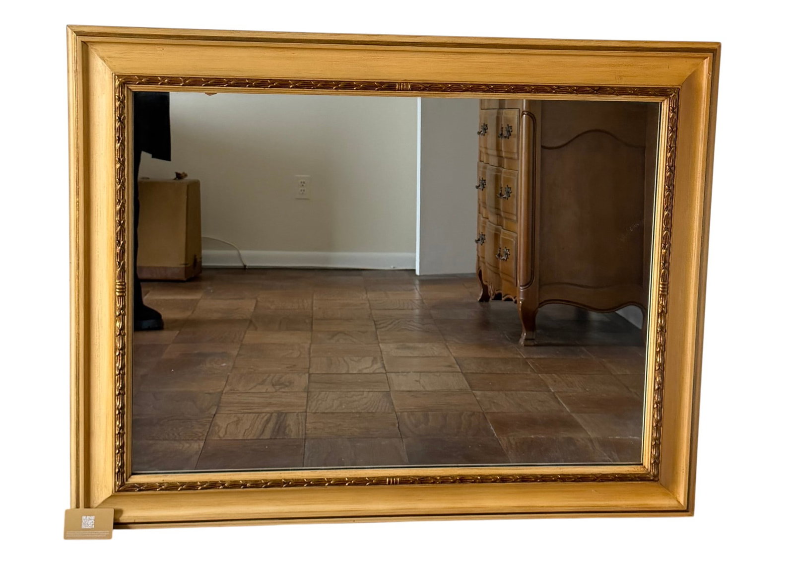 Giltwood Framed Wall Mirror: An elegant giltwood framed wall mirror. The frame features a classic rectangular form with an ornate inner border of applied acanthus leaf molding, finished in a warm, antiqued gold. The mirror plate 