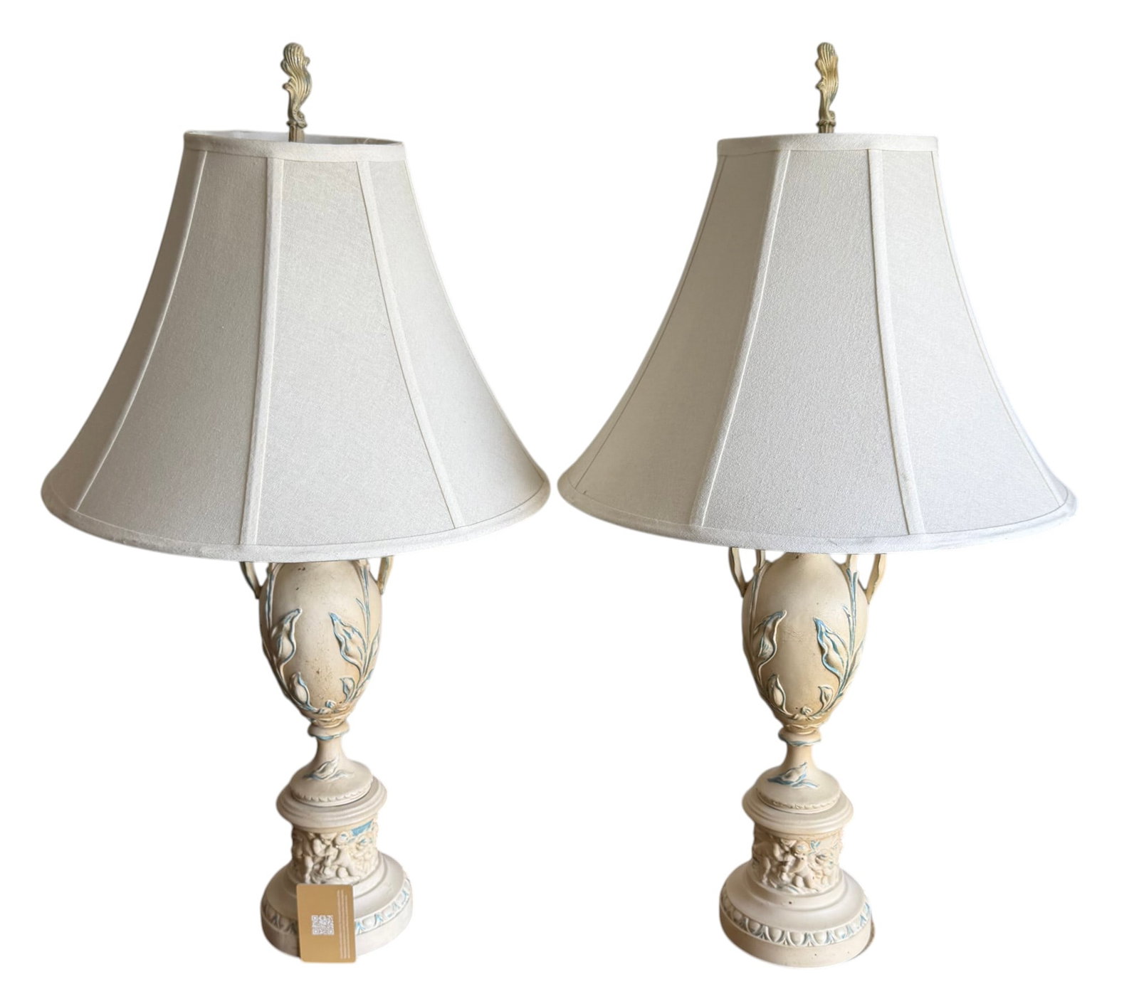 Pair of Ceramic Urn-Form Table Lamps: A pair of ceramic urn-form table lamps, likely from the Mid-20th Century, exhibiting a Neoclassical or Hollywood Regency style. Each lamp features an off-white crackle-glazed body with applied decorat