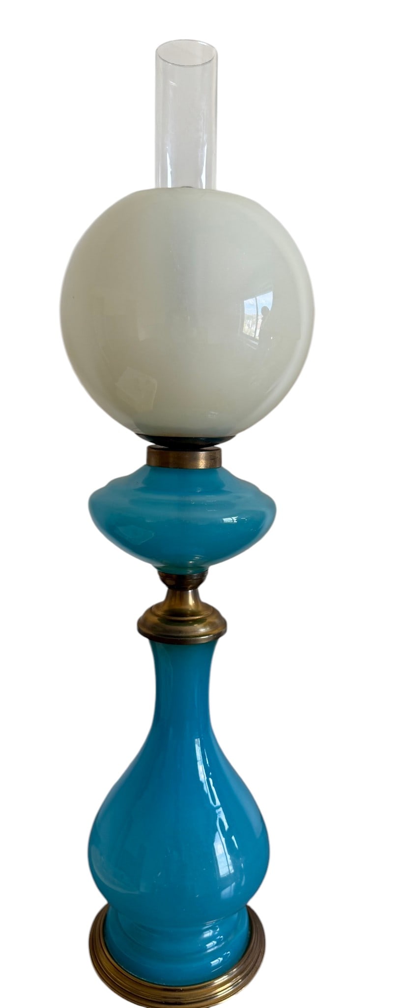 Mid-20th Century Blue and White Opalescent Glass and Brass Table Lamp: A charming Mid-20th Century table lamp, featuring a vibrant robin's egg blue opalescent glass body with a sculptural, curvilinear form. The lamp is accented with polished brass fittings, including a