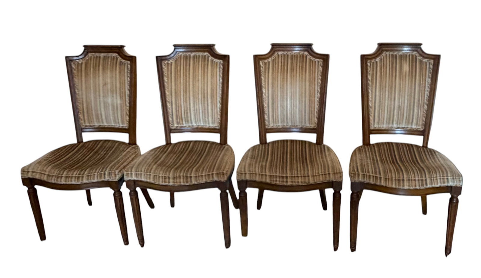 Set of Four French Provincial Style Dining Chairs: A set of four elegant dining chairs in the French Provincial style, likely dating from the mid-20th century. Each chair features a carved wooden frame with a warm, medium-brown finish. The chairs