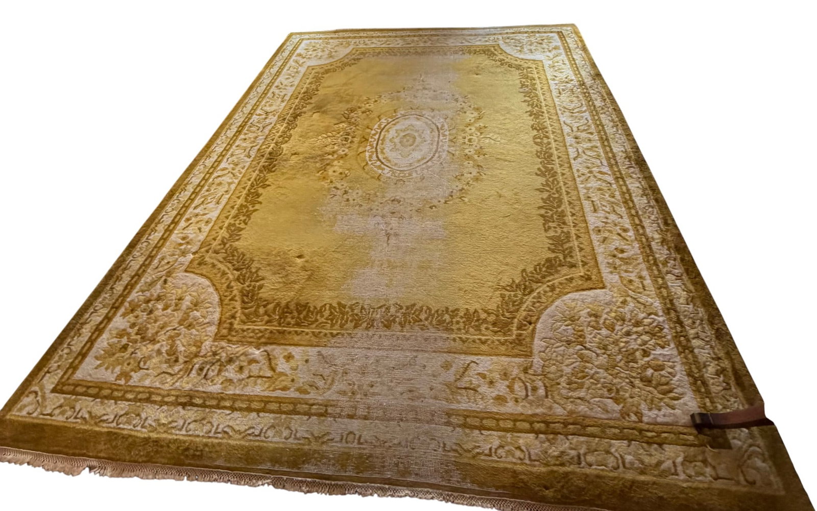 Large Traditional Gold & White Area Rug: A large traditional area rug featuring a central medallion and ornate floral borders in shades of gold and off-white. The rug appears to be machine-made, likely from synthetic fibers such as