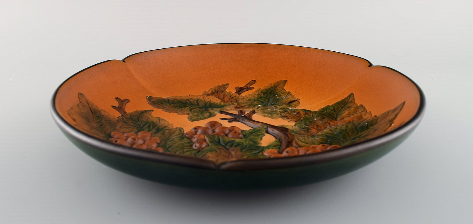 Ipsen's, Denmark. Circular dish with berries and foliage in hand-painted glazed ceramics. Model - 5