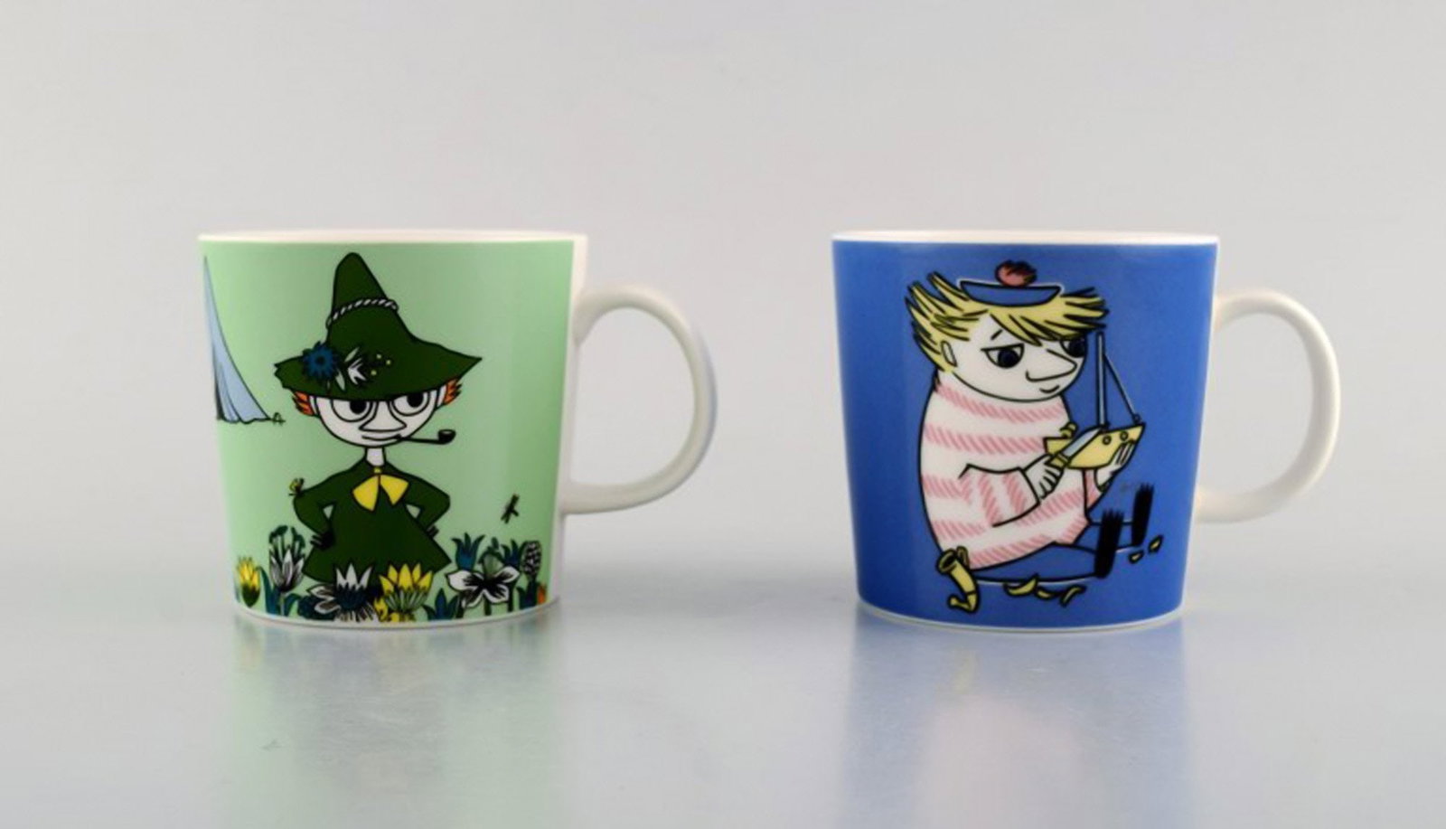 Arabia, Finland. Two cups in porcelain with motifs from "Moomin". Late 20th century.: Brand: Arabia Arabia, Finland. Two cups in porcelain with motifs from "Moomin". Late 20th century. Reserve: $189.00 Shipping: Domestic: Shipping rates are determined by destination International: