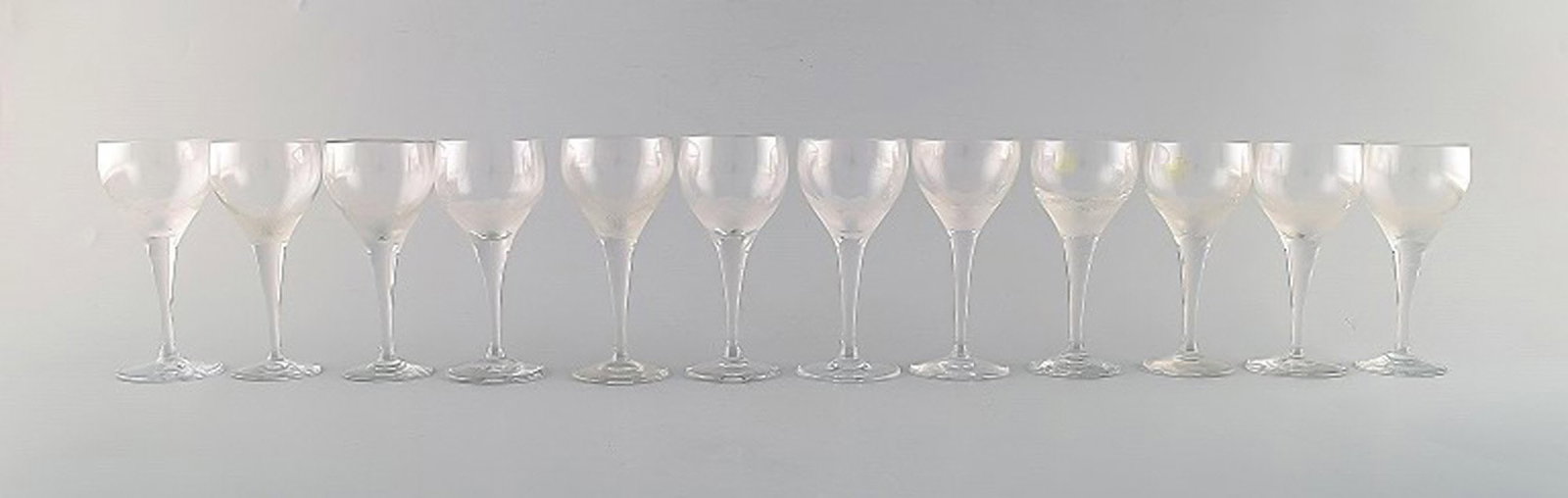 Bjørn Wiinblad (1918-2006) for Rosenthal. Twelve "Lotus" glasses in clear art glass decorated: Brand: Rosenthal Bjørn Wiinblad (1918-2006) for Rosenthal. Twelve "Lotus" glasses in clear art glass decorated with lotus flower. 1980's. Reserve: $413.00 Shipping: Domestic: Shipping rates are
