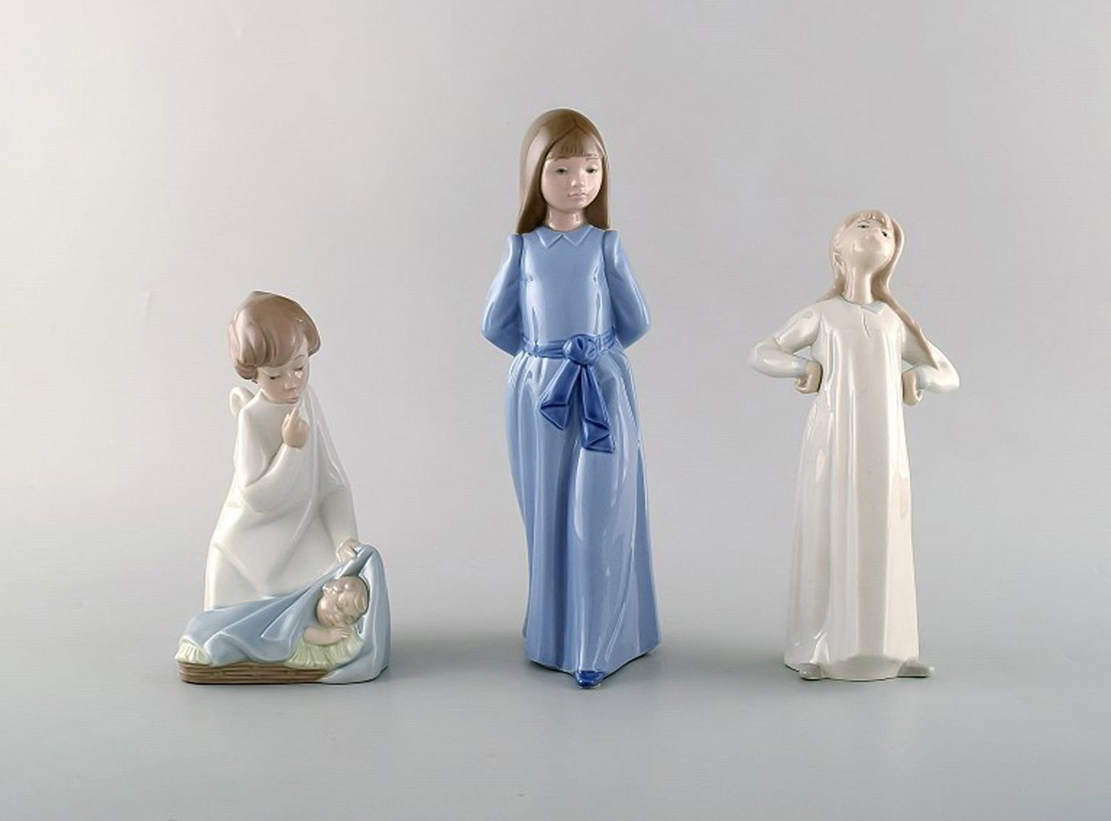 Nao and Lladro. Three porcelain figures. 20th century.: Brand: Lladro Nao and Lladro. Three porcelain figures. 20th century. Reserve: $210.00 Shipping: Domestic: Shipping rates are determined by destination International: Foreign shipping rates are