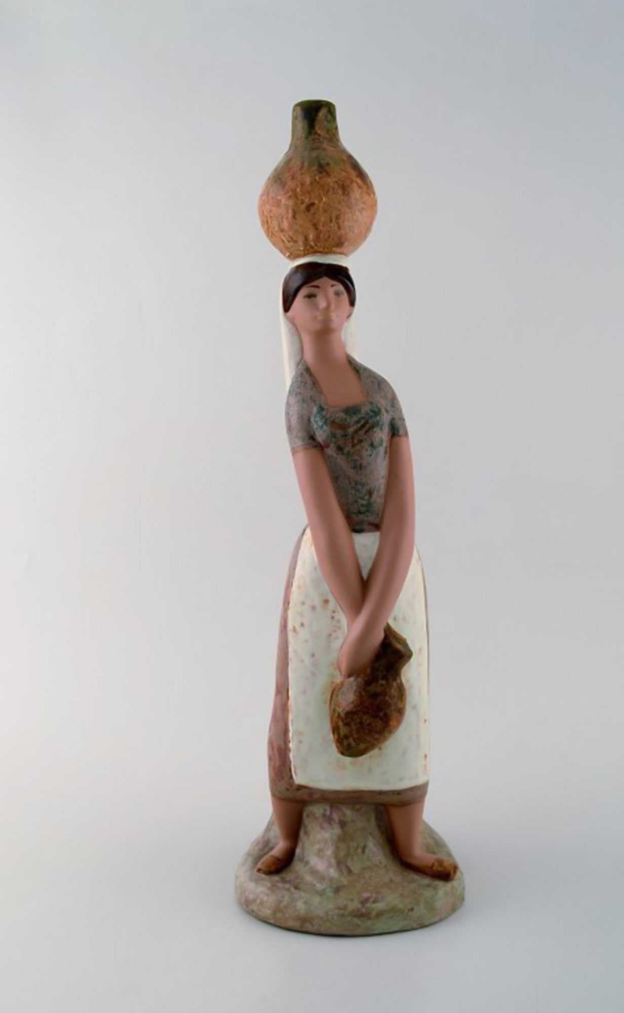 Lladro, Spain. Large figure in glazed ceramics. Woman carrying water. Late 20th century.: Brand: Lladro Lladro, Spain. Large figure in glazed ceramics. Woman carrying water. Late 20th century. Reserve: $238.00 Shipping: Domestic: Shipping rates are determined by destination International: 