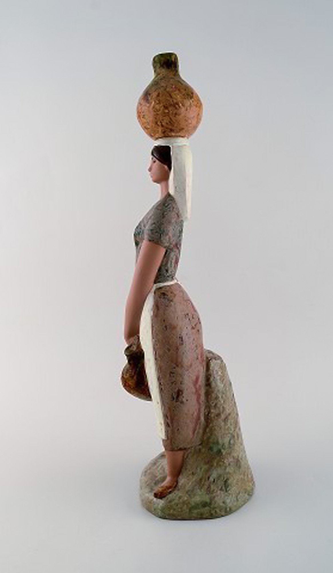 Lladro, Spain. Large figure in glazed ceramics. Woman carrying water. Late 20th century. - 2
