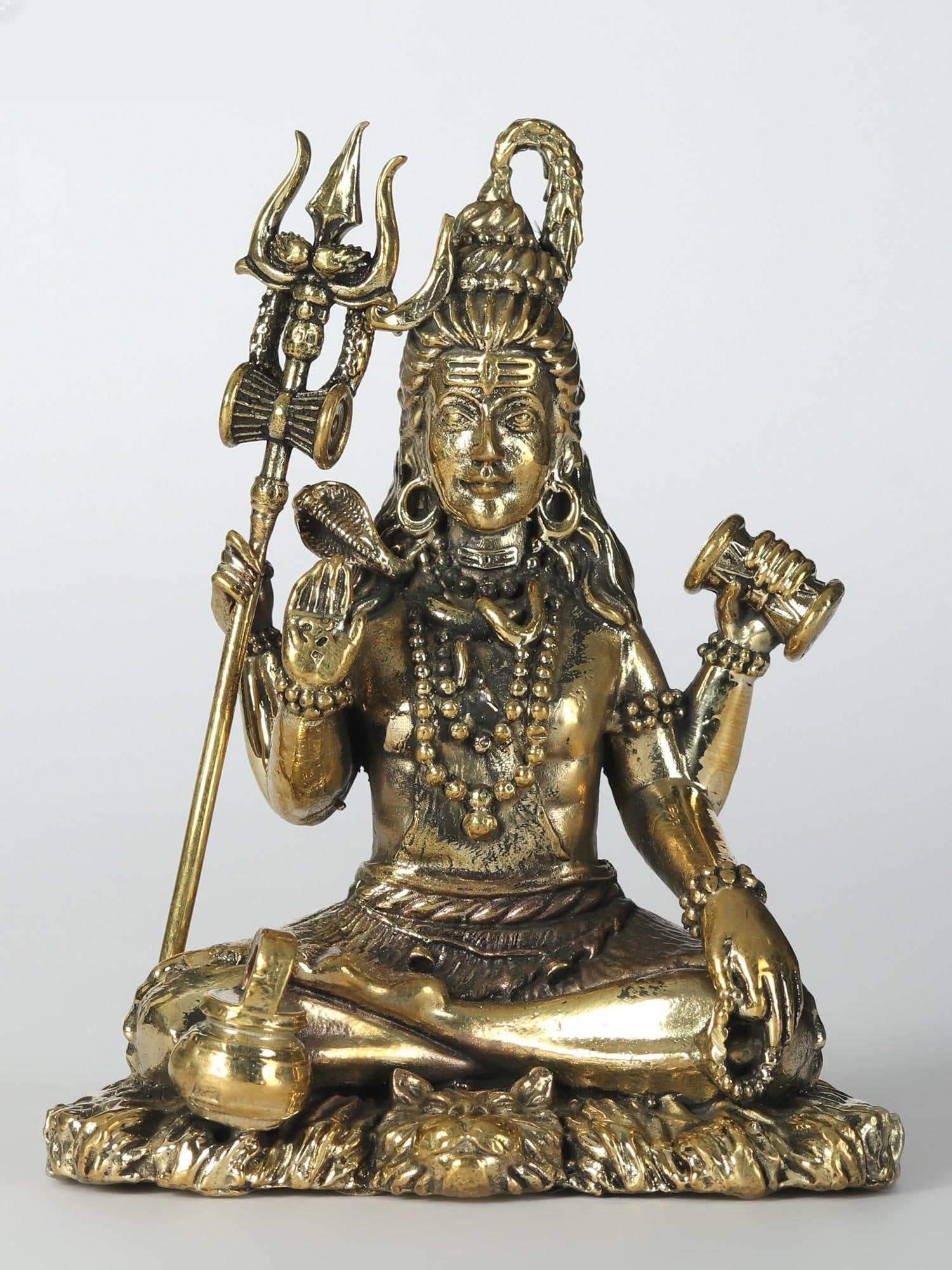 Superfine Idol of Bhole Shankara Small Brass Statue: Title: Superfine Idol of Bhole Shankara Small Brass Statue Description: Shiva, the Auspicious One, transcends mortal essence as the Supreme Lord, weaving cosmic tapestries with creation, protection, a