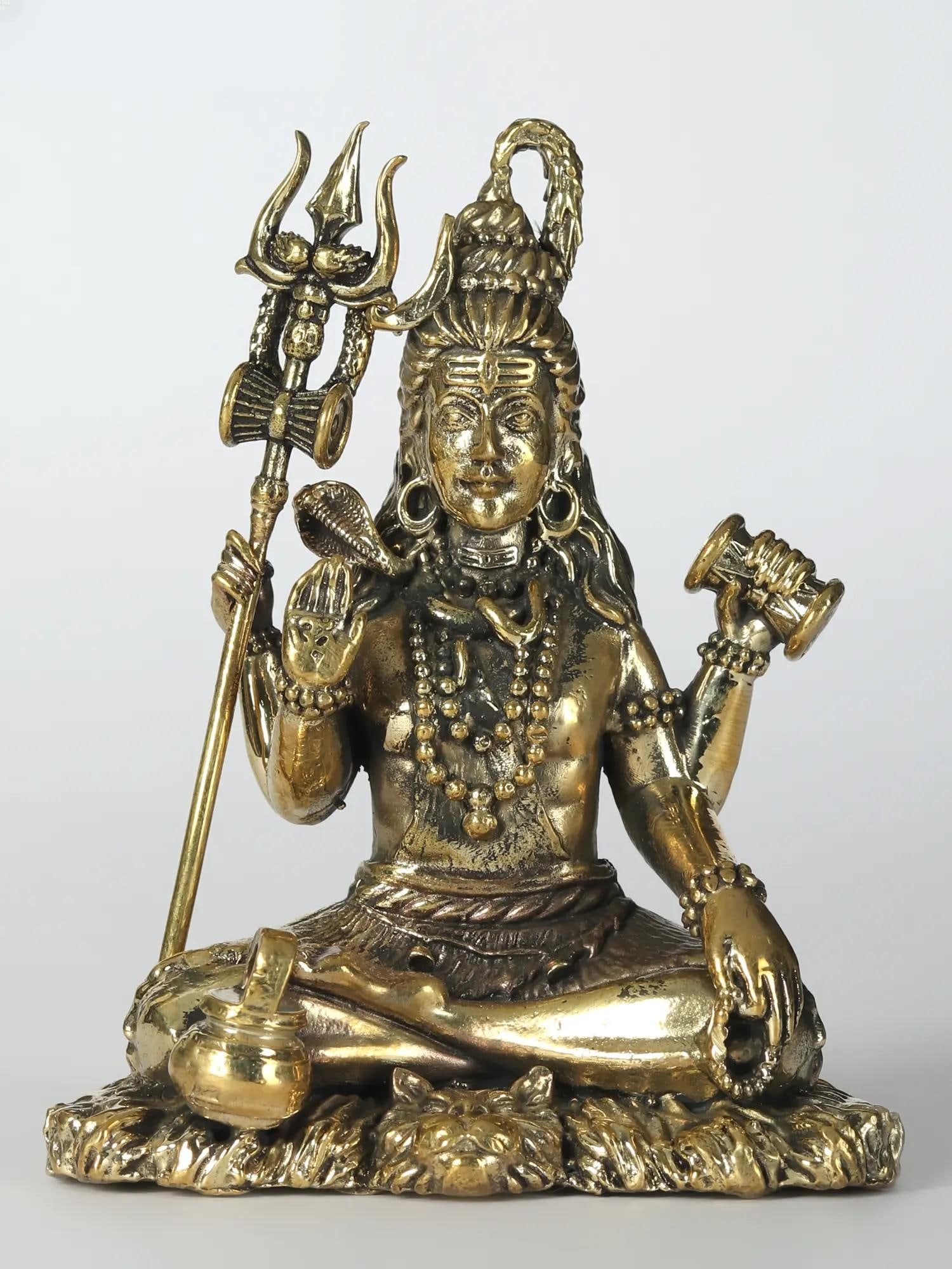 Superfine Idol of Bhole Shankara Small Brass Statue: Title: Superfine Idol of Bhole Shankara Small Brass Statue Description: Shiva, the Auspicious One, transcends mortal essence as the Supreme Lord, weaving cosmic tapestries with creation, protection,
