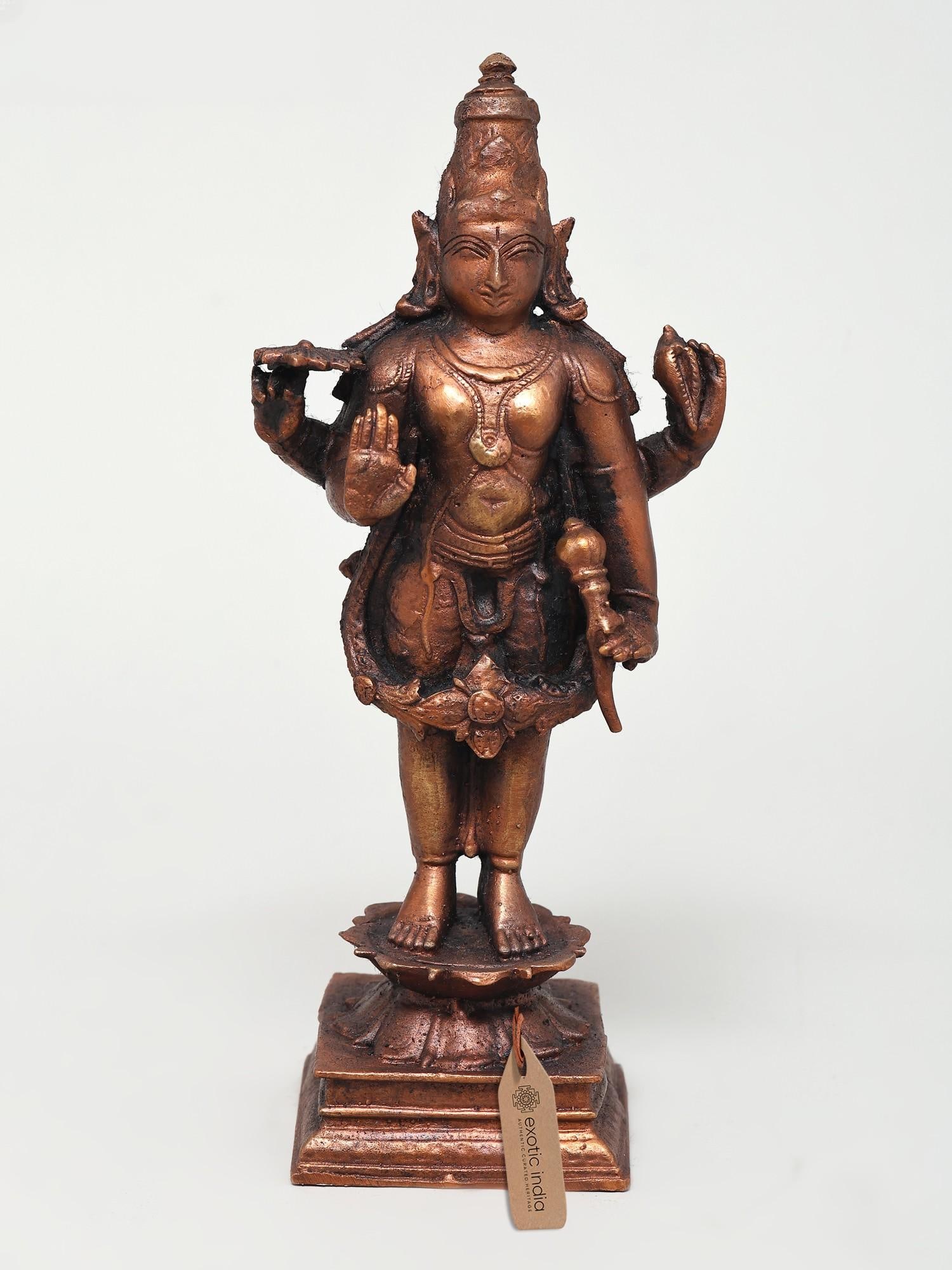 6" Small Standing Lord Vishnu in Blessing Gesture Copper Statue: Title: 6" Small Standing Lord Vishnu in Blessing Gesture Copper Statue Description: Smiling divinely, the great preserver Lord of Hinduism, Sri Vishnu is presented in this small copper statue in his p