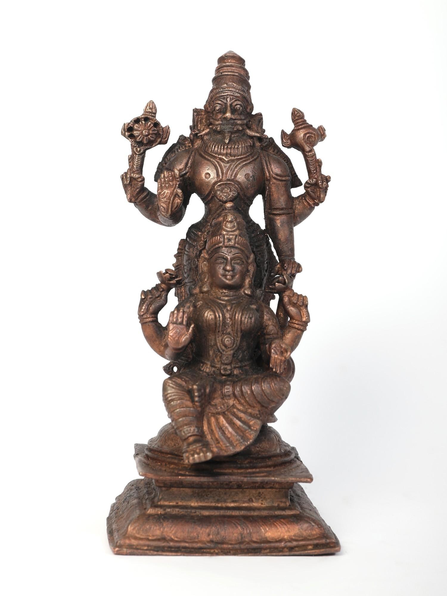 7" Lakshmi - Narasimha Copper Statue: Title: 7" Lakshmi - Narasimha Copper Statue Description: Lakshmi-Narasimha, the dual energies of Sri Vishnu in his man-lion form and his most auspicious Shakti have been revered by early Indian dynast