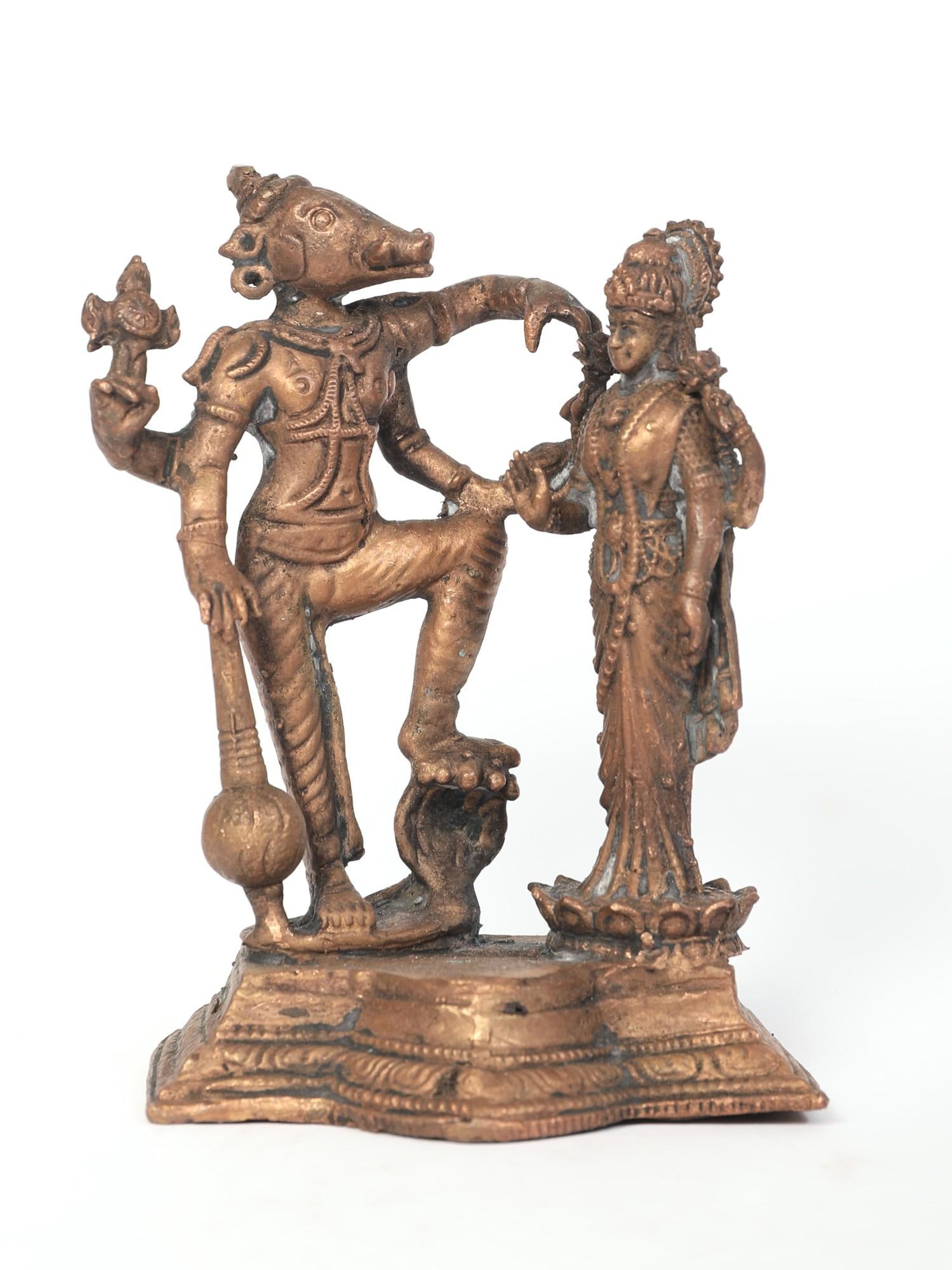 4" Small Standing Lord Varaha and Devi Lakshmi Copper Statue: Title: 4" Small Standing Lord Varaha and Devi Lakshmi Copper Statue Description: Sri Varah, Vishnu's incarnation as a boar who carried the goddess Earth from the depths of the ocean, to reinstate
