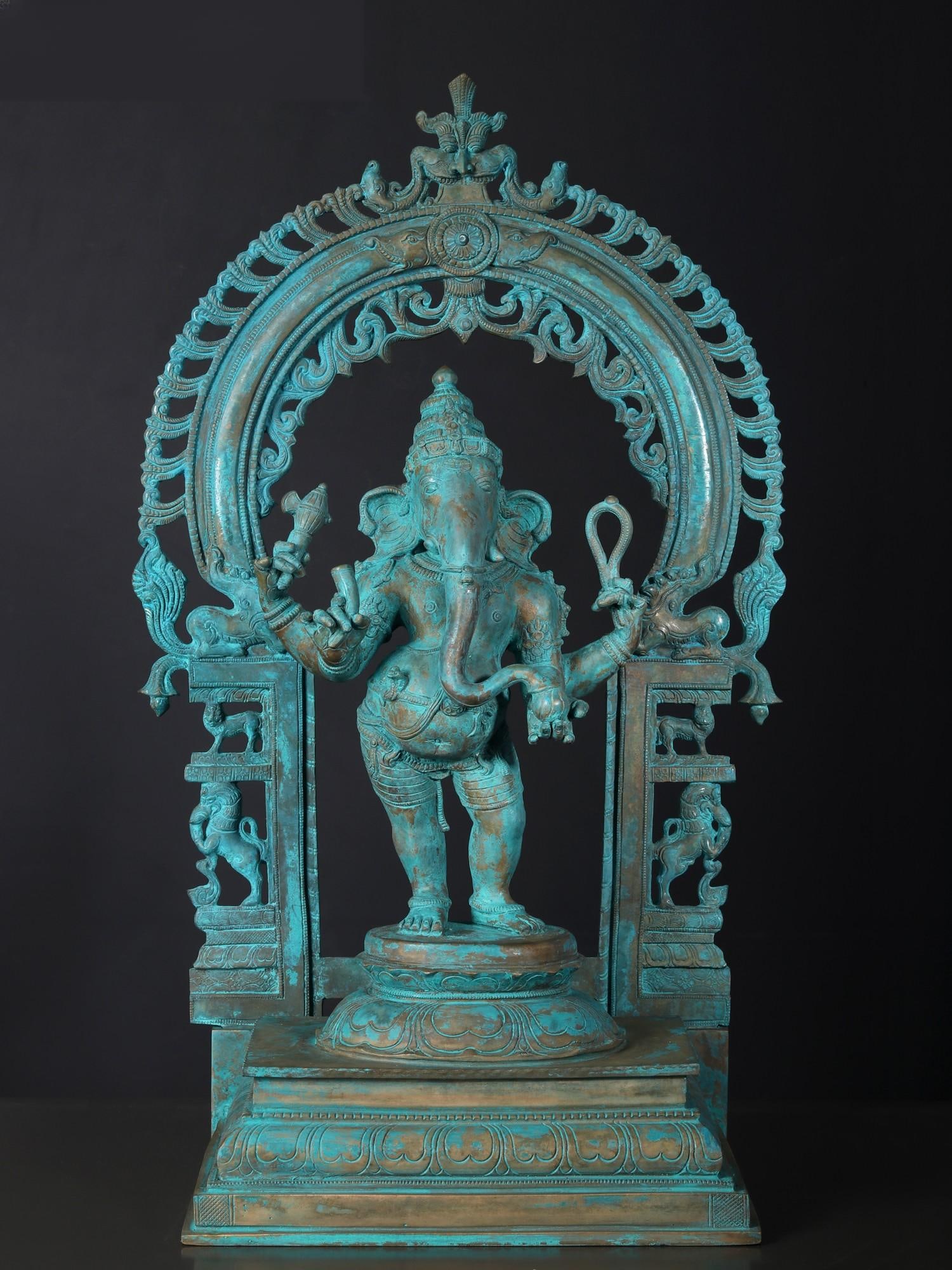 24" Chaturbhuja Lord Ganesha with Kirtimukha Arch | Bronze Statue: Title: 24" Chaturbhuja Lord Ganesha with Kirtimukha Arch | Bronze Statue Description: Beautifed with antique green patina, this classic Panchaloha bronze is a masterpiece, an artistic depiction of Gan