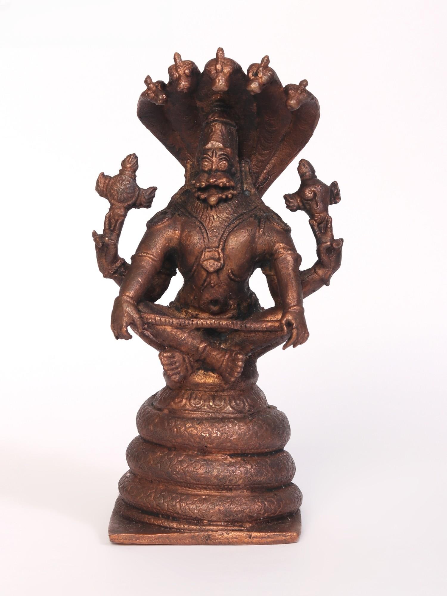 5" Yoga Narasimha Idol Seated on Sheshnag | Copper Statue: Title: 5" Yoga Narasimha Idol Seated on Sheshnag | Copper Statue Description: The Yoga Narasimha Seated on Sheshnag Copper Statue is a divine fusion of strength and tranquility. With a belt (Yogapatta