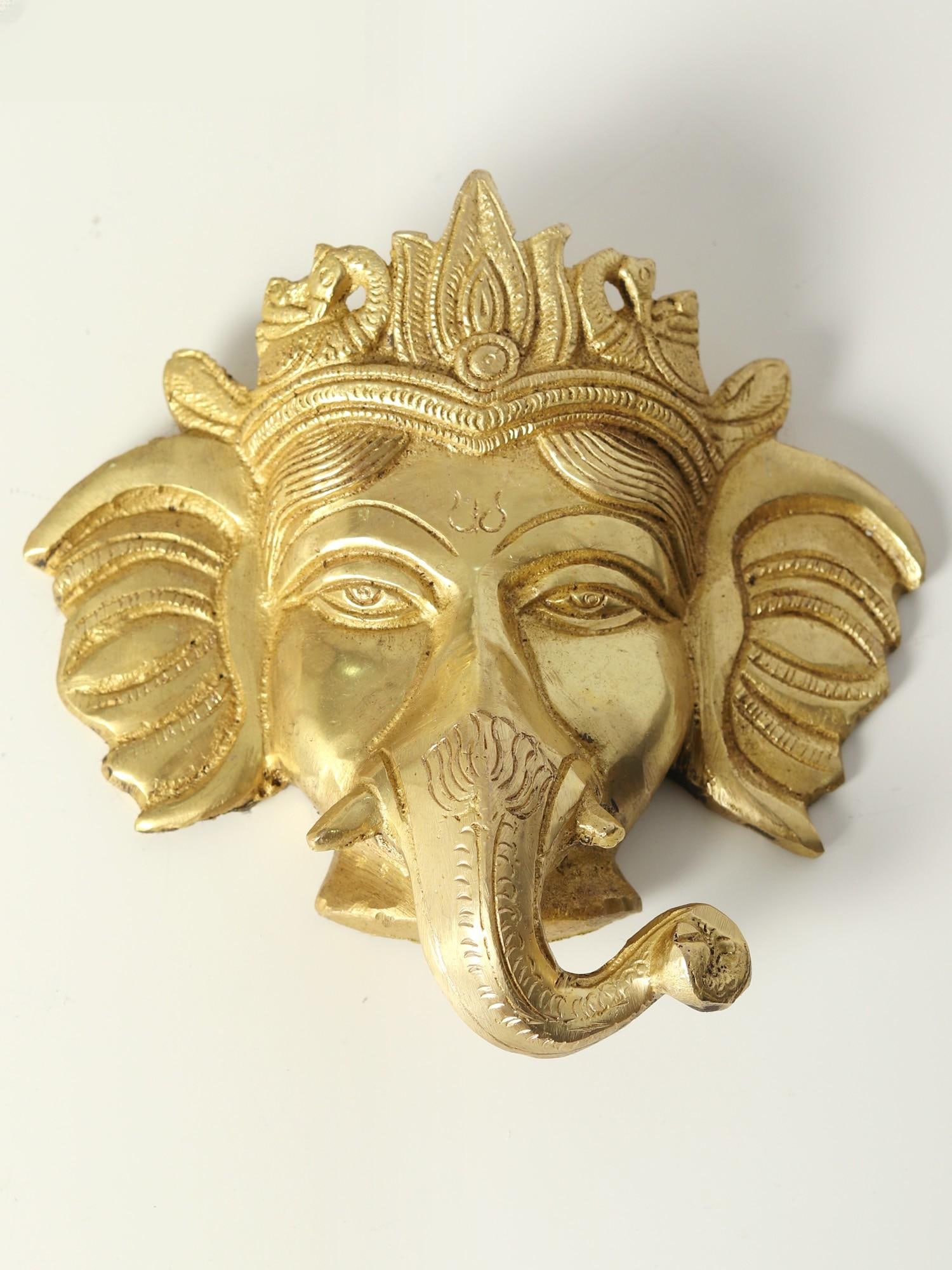 5" Small Ganesha Face Wall Hanging Statue in Brass: Title: 5" Small Ganesha Face Wall Hanging Statue in Brass Description: Mahesvaram Samaasraye Paratparam Nirantaram. This shows that devotee mediates endlessly on Him, the Lord of the Ganas, who