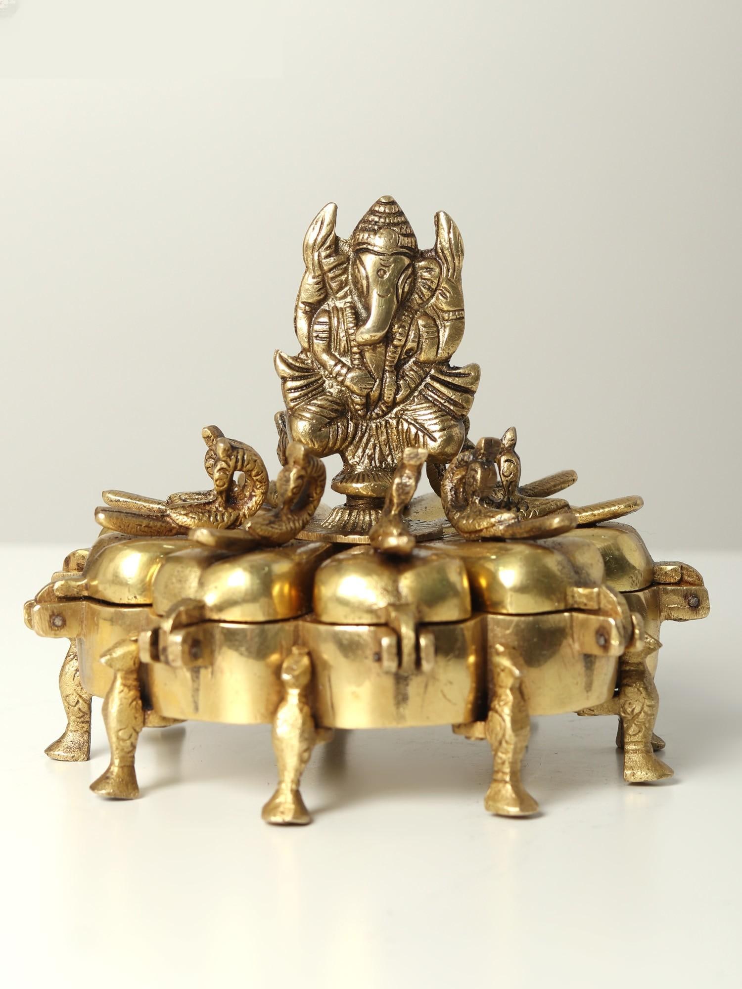 5" Small Ganesha Puja Box in Brass: Title: 5" Small Ganesha Puja Box in Brass Description: This Small Ganesha Puja Box in Brass, featuring the sacred image of Lord Ganesha, is a ceremonial artifact that mixes religious iconography and r