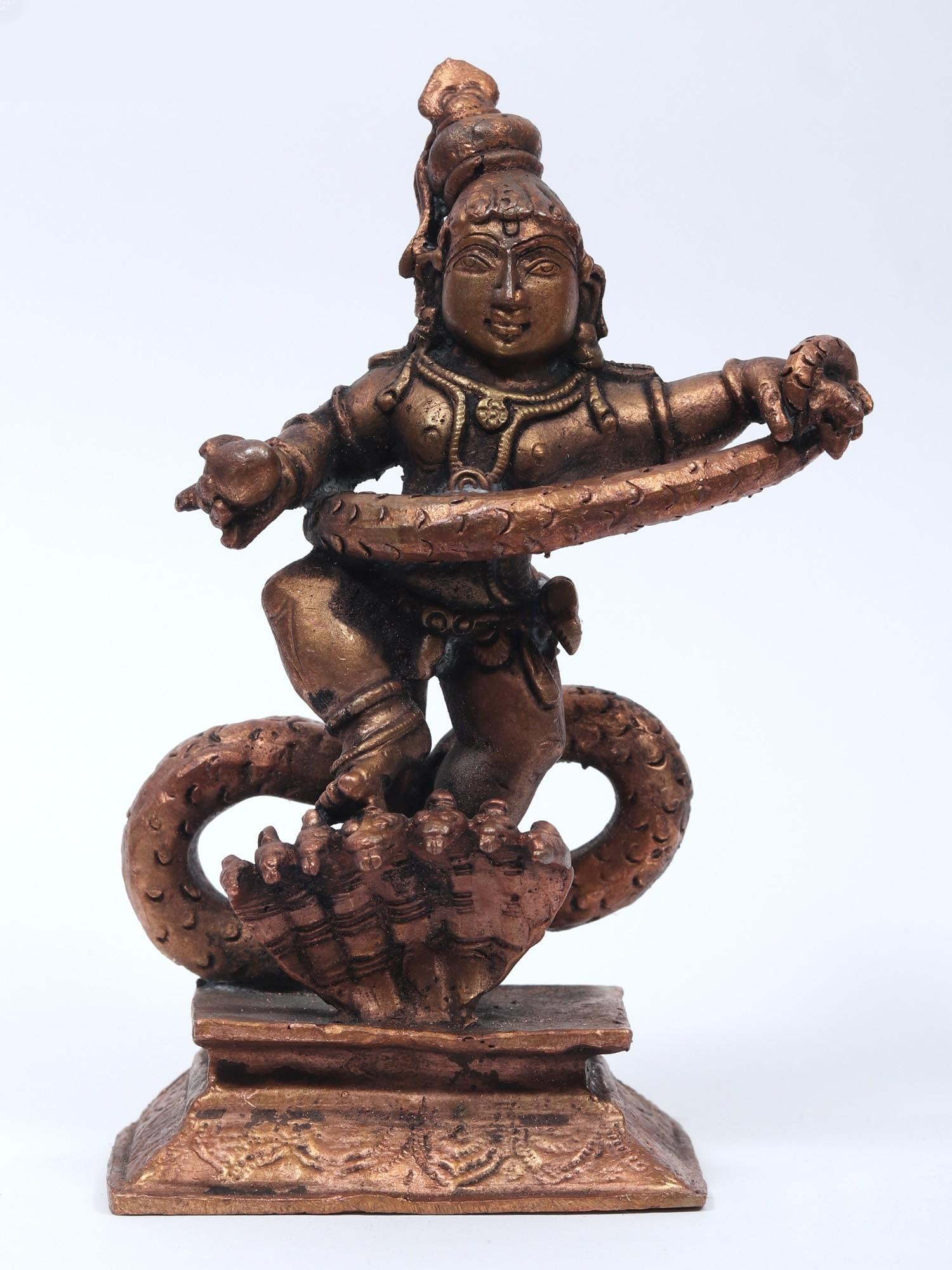 5" Small Kaliya Mardan Krishna Copper Statue: Title: 5" Small Kaliya Mardan Krishna Copper Statue Description: Kaliya Mardan is not only a Krishna Leela incident, but also a magnificent account of Lord Krishna's lovely dance on the hood of the