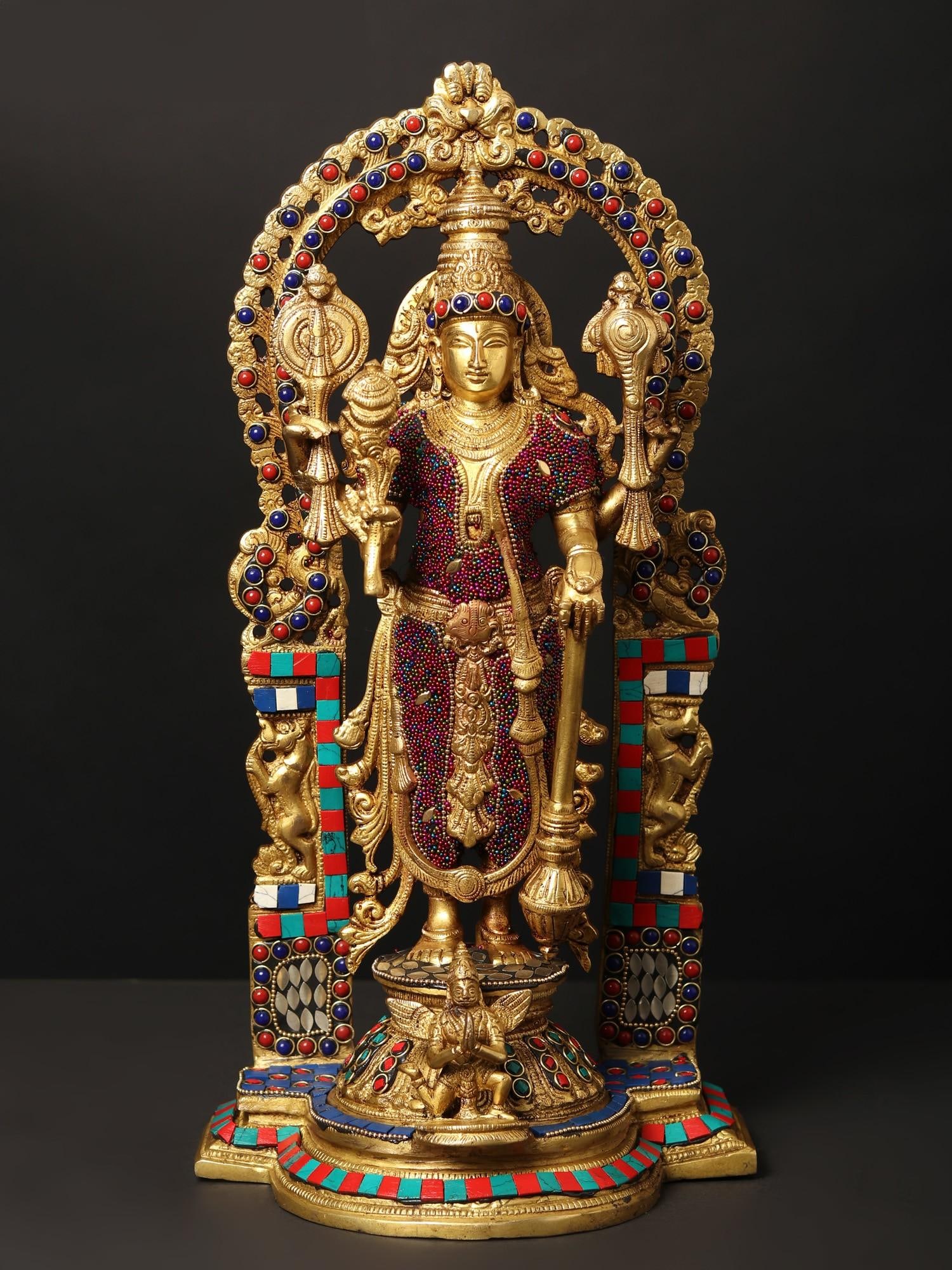 16" Standing Lord Vishnu on Kirtimukha Throne with Garuda | Brass Statue with Inlay Work: Title: 16" Standing Lord Vishnu on Kirtimukha Throne with Garuda | Brass Statue with Inlay Work Description: This Brass statue of Lord Vishnu, standing beneath a Kirtimukha Prabhavali, exudes divine g