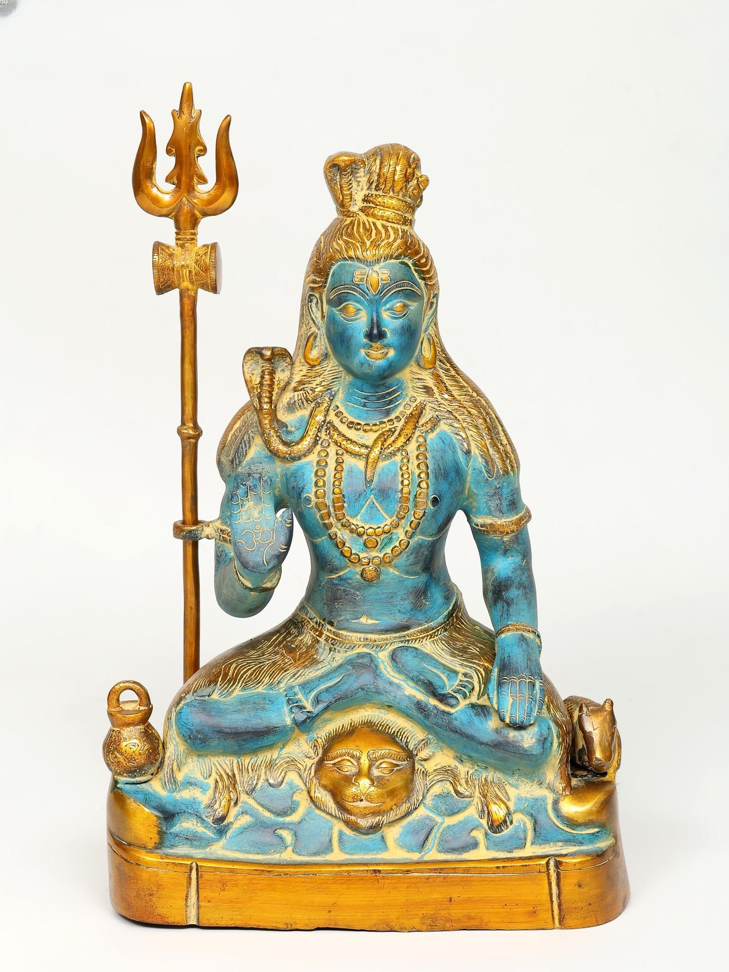 17" Sitting Lord Shiva Idol in Blessing Gesture | Brass Statue: Title: 17" Sitting Lord Shiva Idol in Blessing Gesture | Brass Statue Description: The brass sculpture of Sitting Lord Shiva in a Blessing Gesture holds profound significance in Hinduism, evoking a se