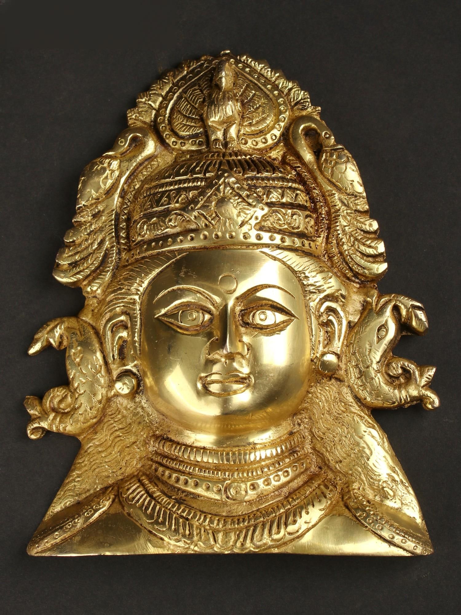 6" Brass Goddess Durga Wall Hanging Mask with Fish Shaped Earrings: Title: 6" Brass Goddess Durga Wall Hanging Mask with Fish Shaped Earrings Description: Embrace the invincible power of Durga with this captivating brass wall hanging mask. The details showcase her fie