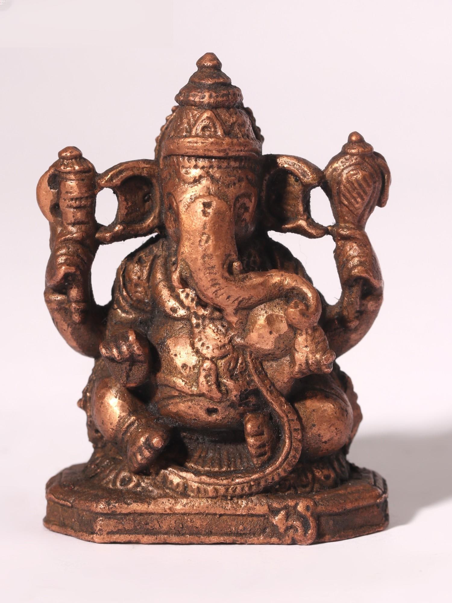 2" Small Four-Armed Lord Ganesha Copper Statue: Title: 2" Small Four-Armed Lord Ganesha Copper Statue Description: This Small Four-Armed Lord Ganesha Copper Statue is a perfect addition to any personal worship space, providing devotees with a