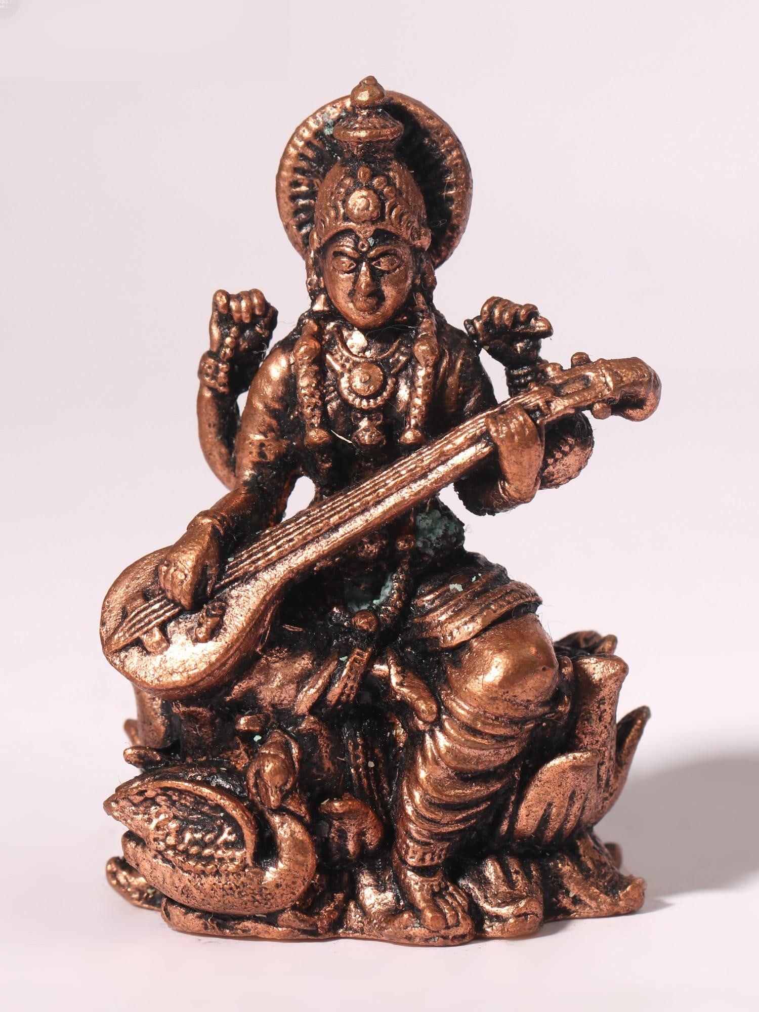 2" Four-Armed Goddess Saraswati Idol Seated on Lotus | Copper Statue: Title: 2" Four-Armed Goddess Saraswati Idol Seated on Lotus | Copper Statue Description: Goddess Saraswati, in Vedic tradition, symbolizes knowledge, wisdom, and the arts. Daily worship is deemed