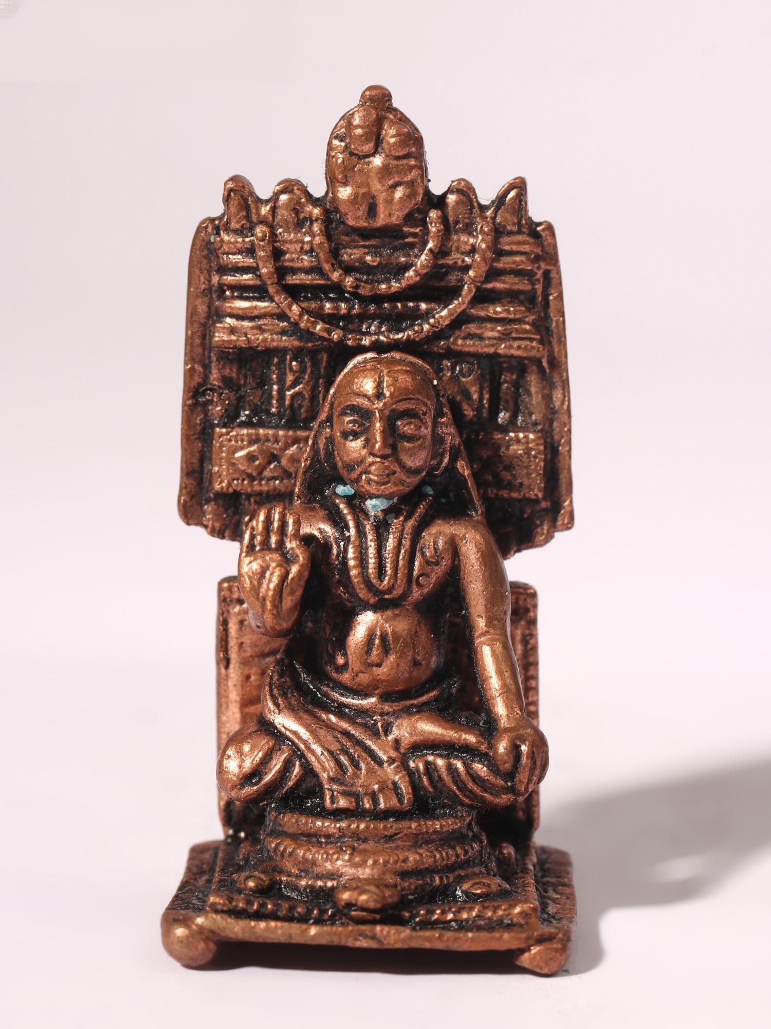 2" Small Raghavendra Swami Copper Statue: Title: 2" Small Raghavendra Swami Copper Statue Description: This Small Raghavendra Swami Copper Statue pays homage to the revered saint, offering devotees a tangible connection to seek daily