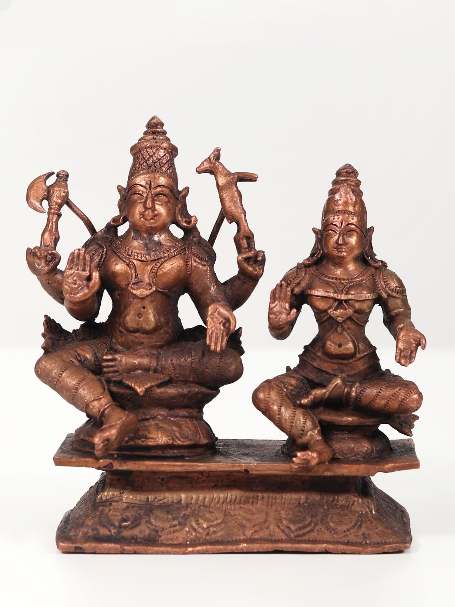 4" Shiva Parvati Copper Statue Seated Together: Title: 4" Shiva Parvati Copper Statue Seated Together Description: The Shiva Purana extols the co-powers of Lord Shiva and Goddess Parvati, emphasizing their inseparable divine synergy. Worshipping th