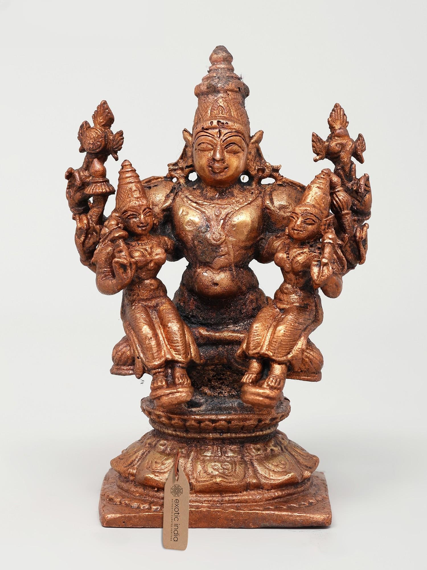 4" Small Lord Vishnu with His Consorts Sridevi and Bhudevi | Copper Statue: Title: 4" Small Lord Vishnu with His Consorts Sridevi and Bhudevi | Copper Statue Description: The Small Lord Vishnu with His Consorts Sridevi and Bhudevi Copper Statue radiates divine harmony. Crafte