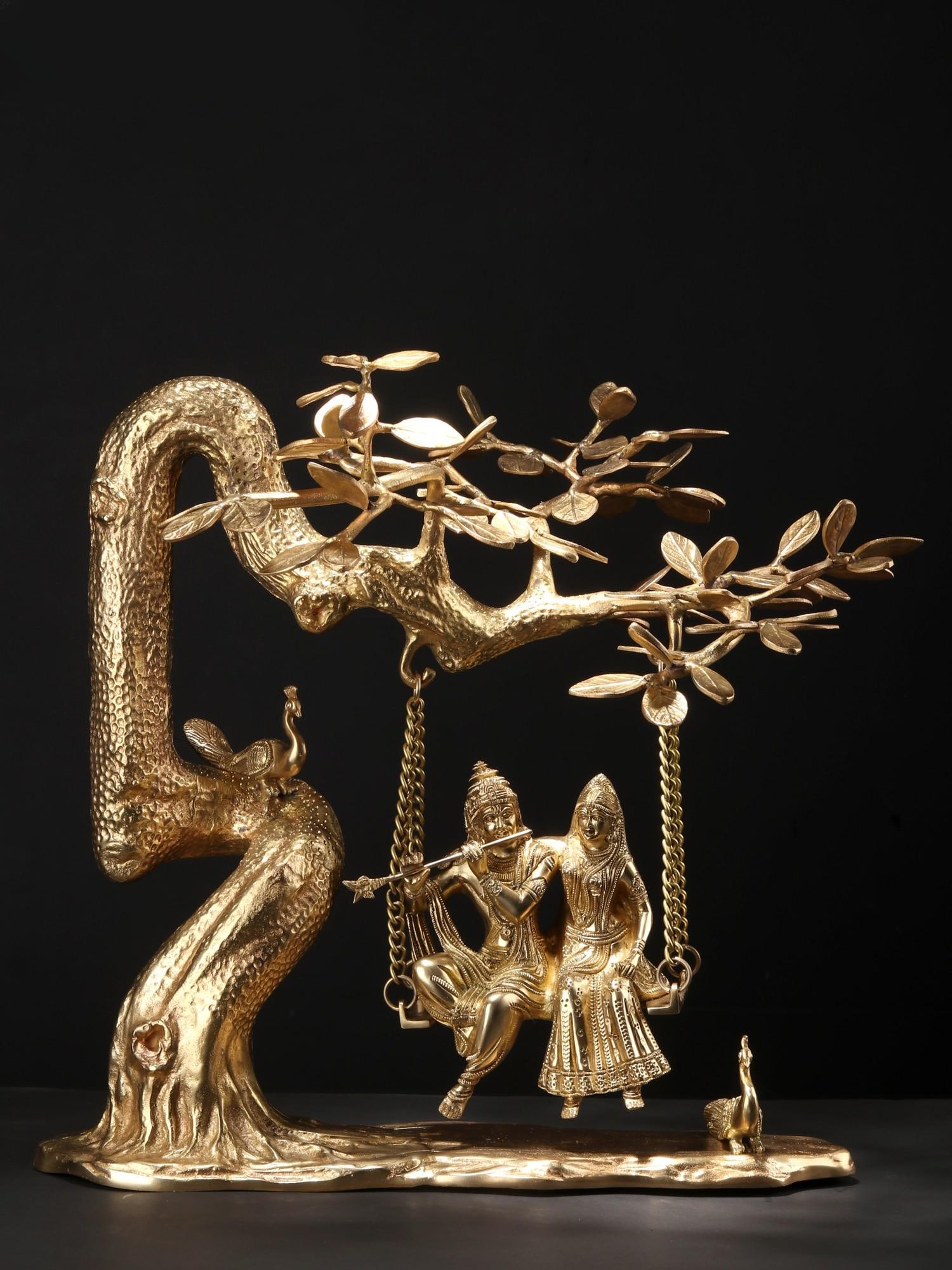 18" Radha Krishna Idol Swinging on Kadamba Tree | Brass Statue: Title: 18" Radha Krishna Idol Swinging on Kadamba Tree | Brass Statue Description: This Brass Statue captures the divine essence of Radha and Krishna , beautifully depicting them swinging on a